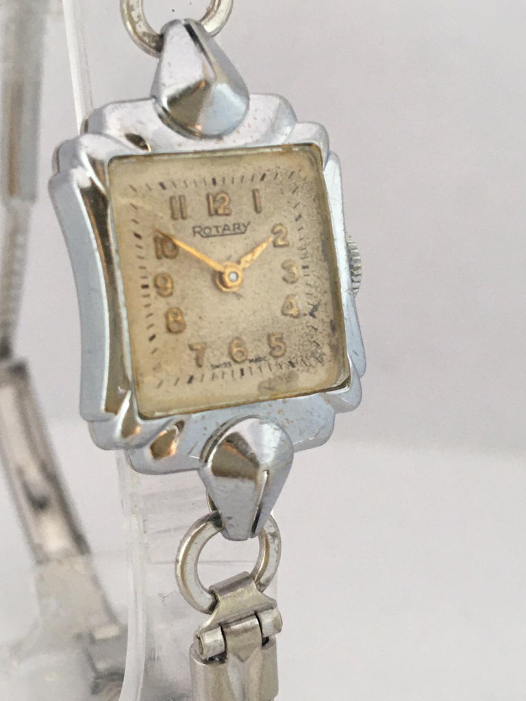 This beautiful pre-owned vintage hand winding watch is in good working condition and it is running well. Visible signs of ageing and wear with small and light scratches on the watch case as shown. The winder is a bit tarnished as shown. The dial
