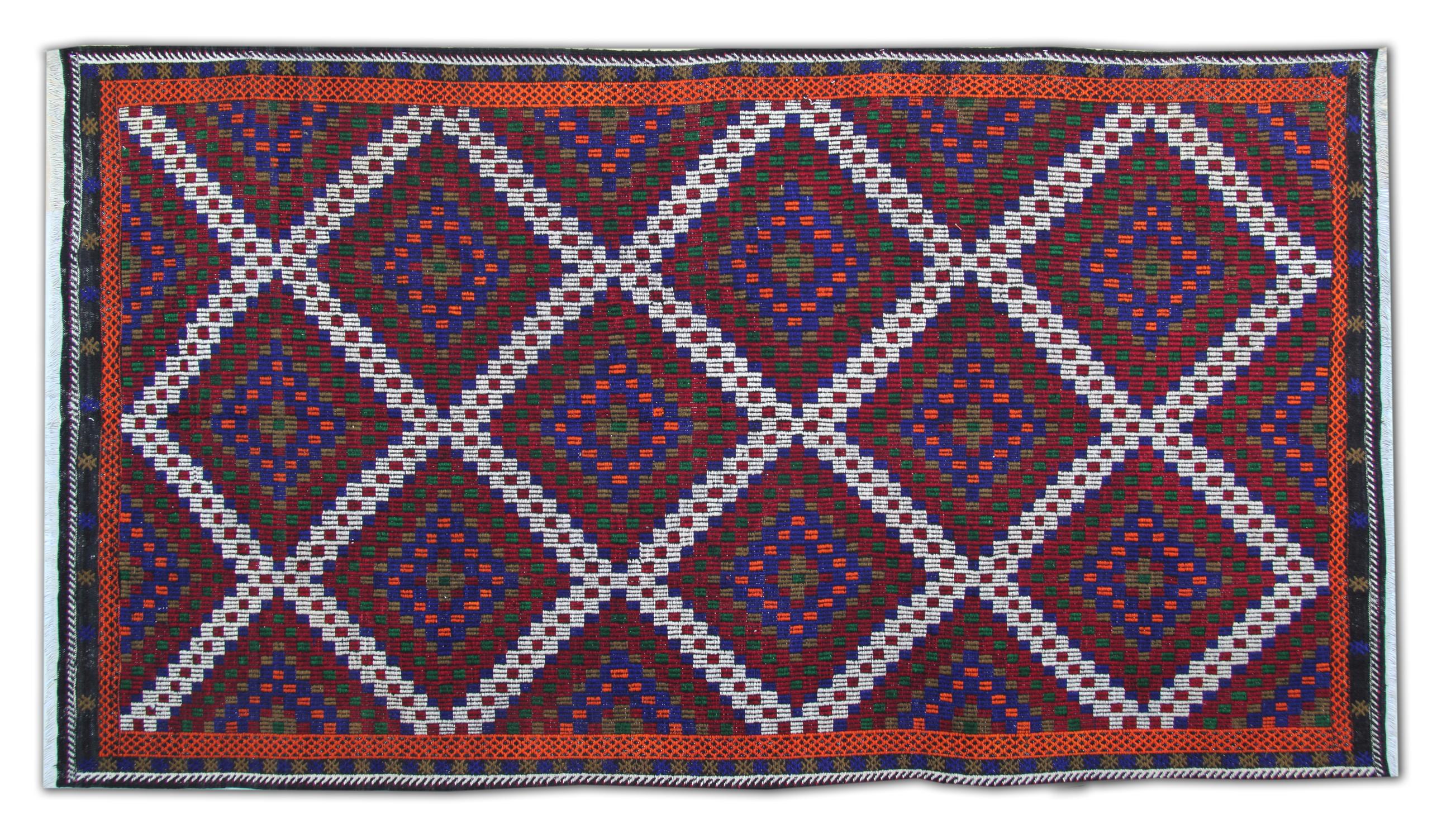 This vintage 1940s handmade Turkman Kilim rug is a striking example of tribal rug artistry, featuring a bold geometric diamond lattice design woven in deep burgundy, navy, and multicoloured accents. Crafted from natural wool on a cotton foundation,