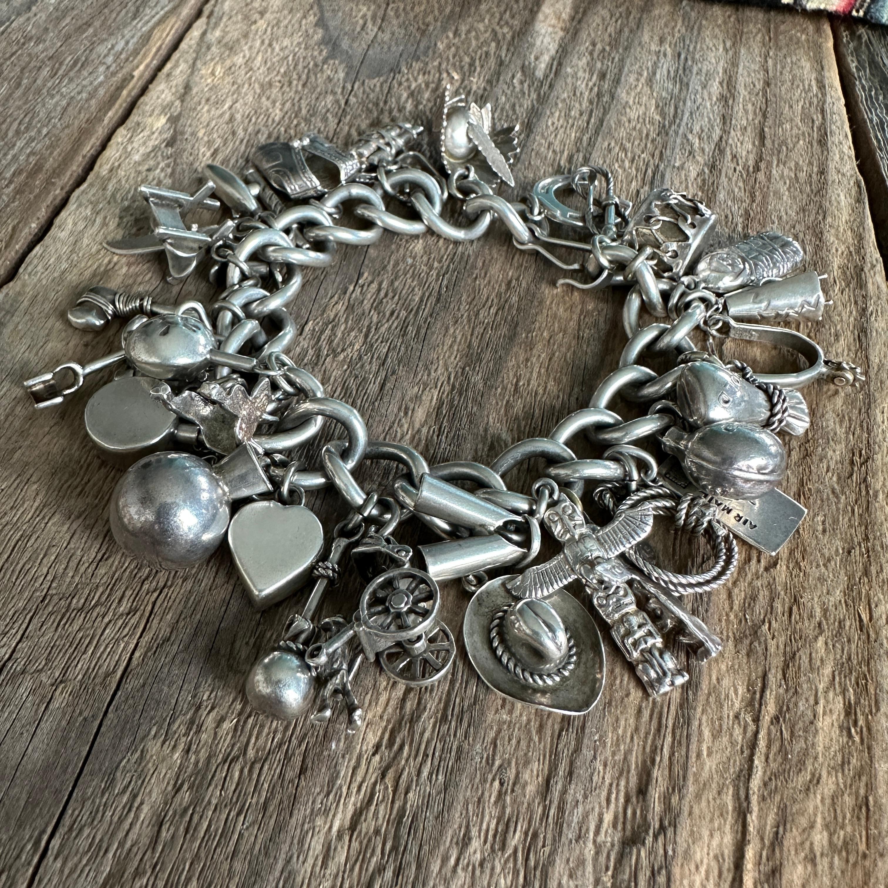 Details:
Sweet western themed 1900-1940's vintage charm bracelet in sterling silver. A great collection of (33) silver charms including horseshoe, cowboy hat, cowboy boot, strirrups, chaps, ropes, feathered headdress, totem pole, papoose, teepee,
