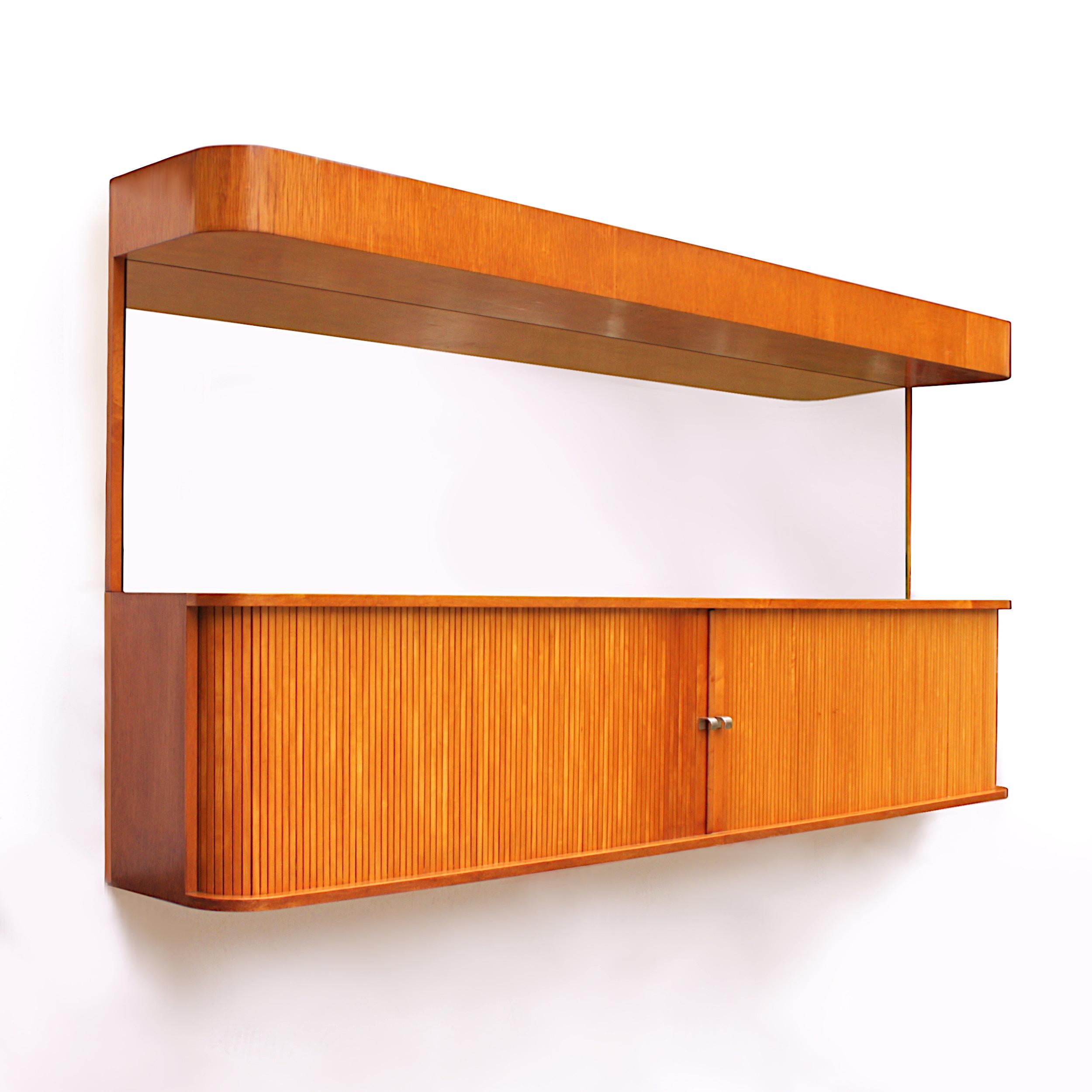 This remarkable piece is a one-off, wall-hanging bar/sideboard/mirror combo. It was custom designed by George Nelson in 1949 to match his Basic Cabinet Series (BCS) for Herman Miller. The consignor was a tenant in the Promontory Apartment Building