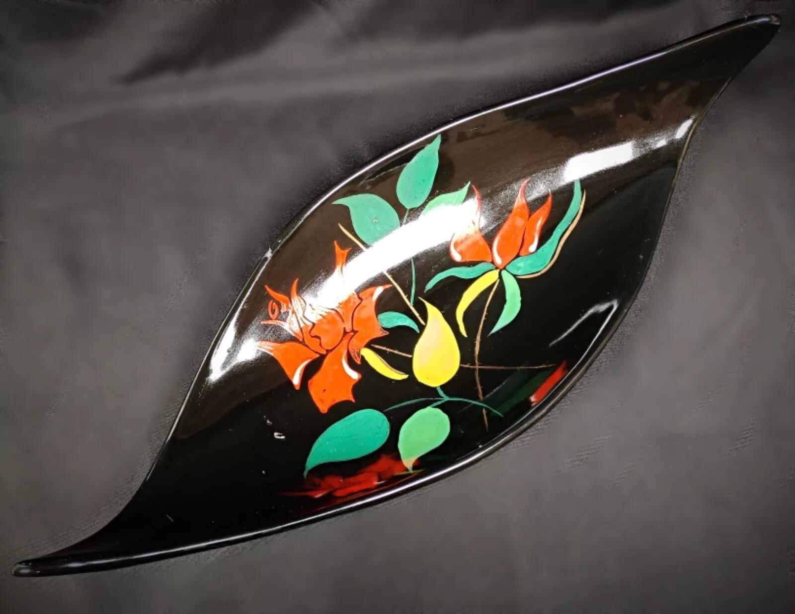 This exquisite vintage Longwy Bagatelle platter/tray from 1950 features a stunning hand-painted floral design, showcasing the timeless craftsmanship of the renowned Longwy ceramic artisans. The vibrant floral motifs and elegant form make it a