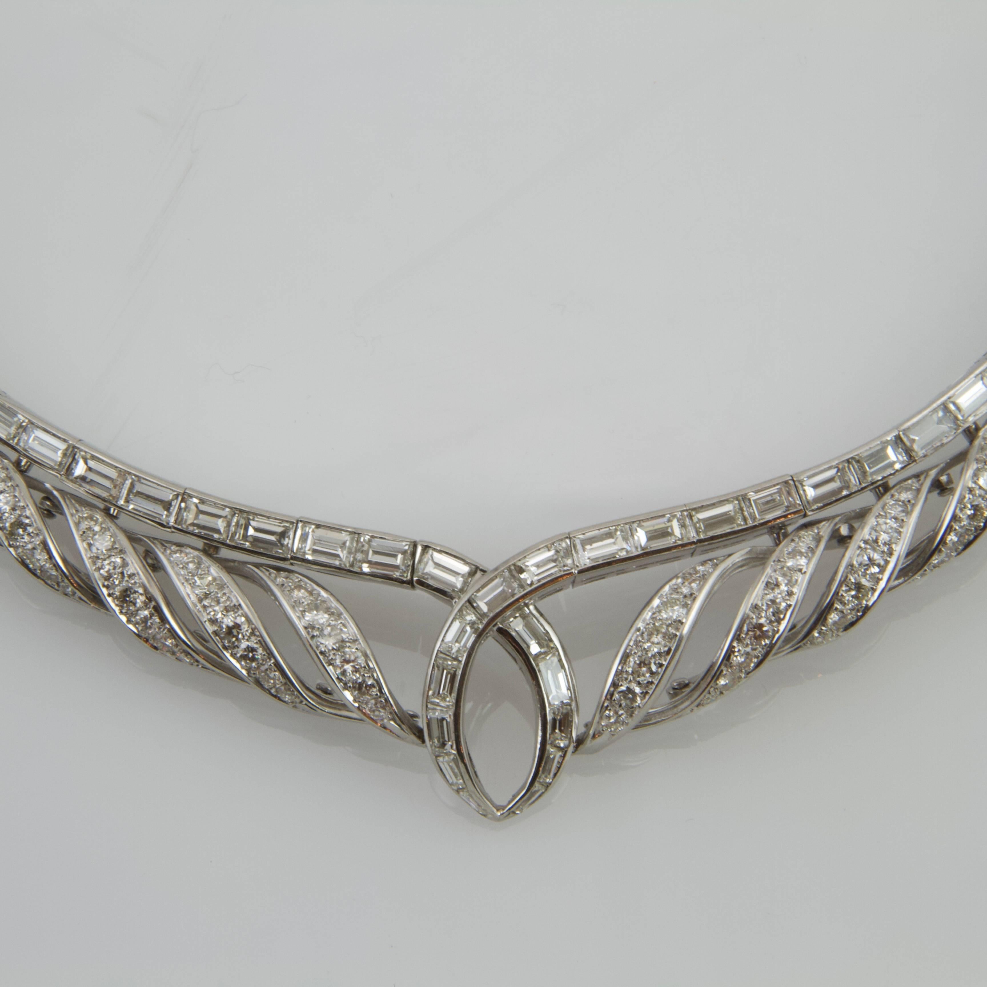 18kt white gold and platinum waterfall patterned necklace. Each volute turned into a spiral set with brilliant cut diamond. The core pattern is stud with baguette diamond. 
Total weight of diamonds estimated around 18 to 20 carats. 
Great design