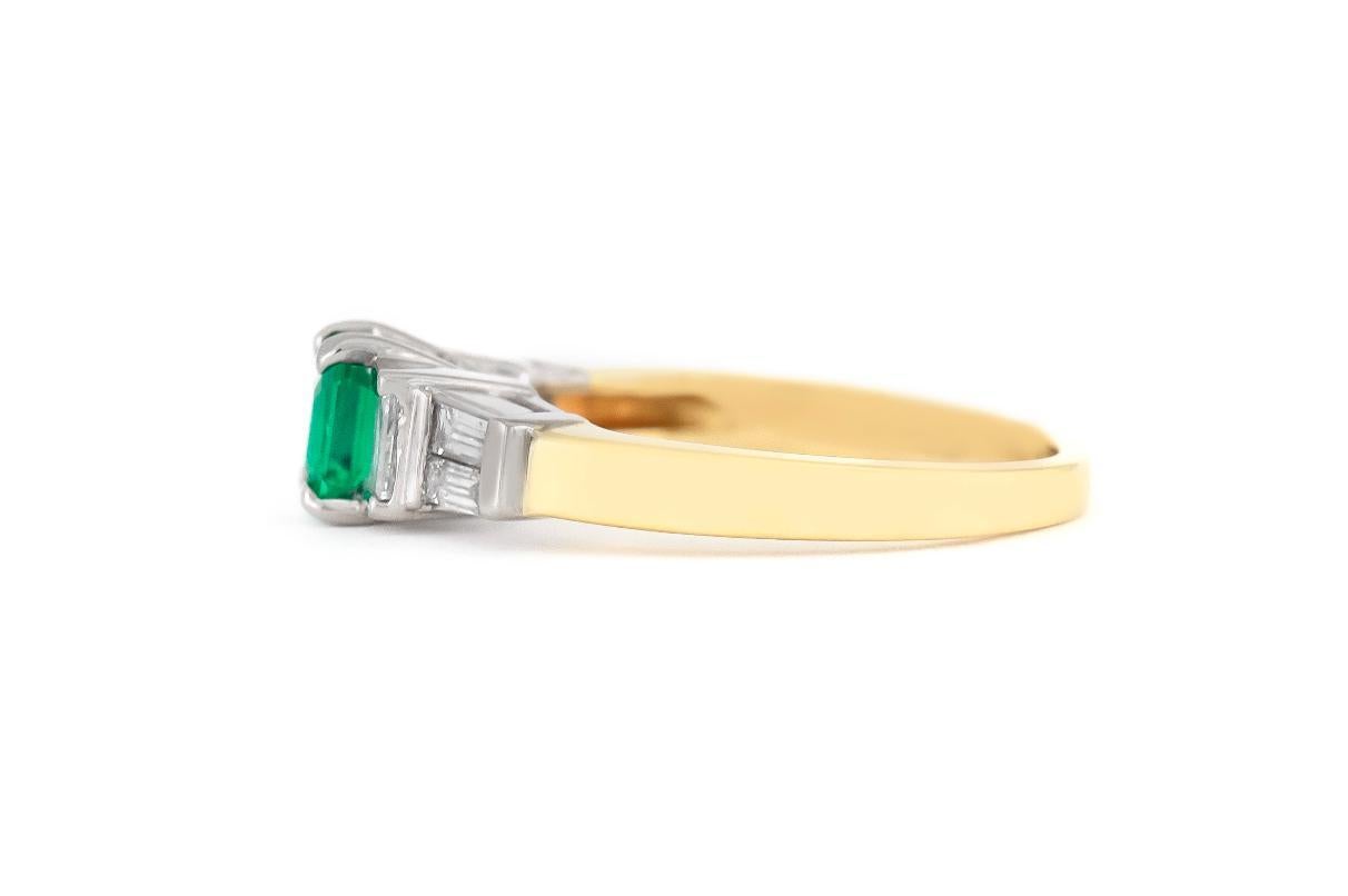 Finely crafted in 14k yellow gold and platinum featuring an Emerald cut Emerald weighing approximately 0.60 carat and side Baguette cut Diamonds weighing a total of approximately 0.50 carat. 
Circa 1950s
Size 7, resizable