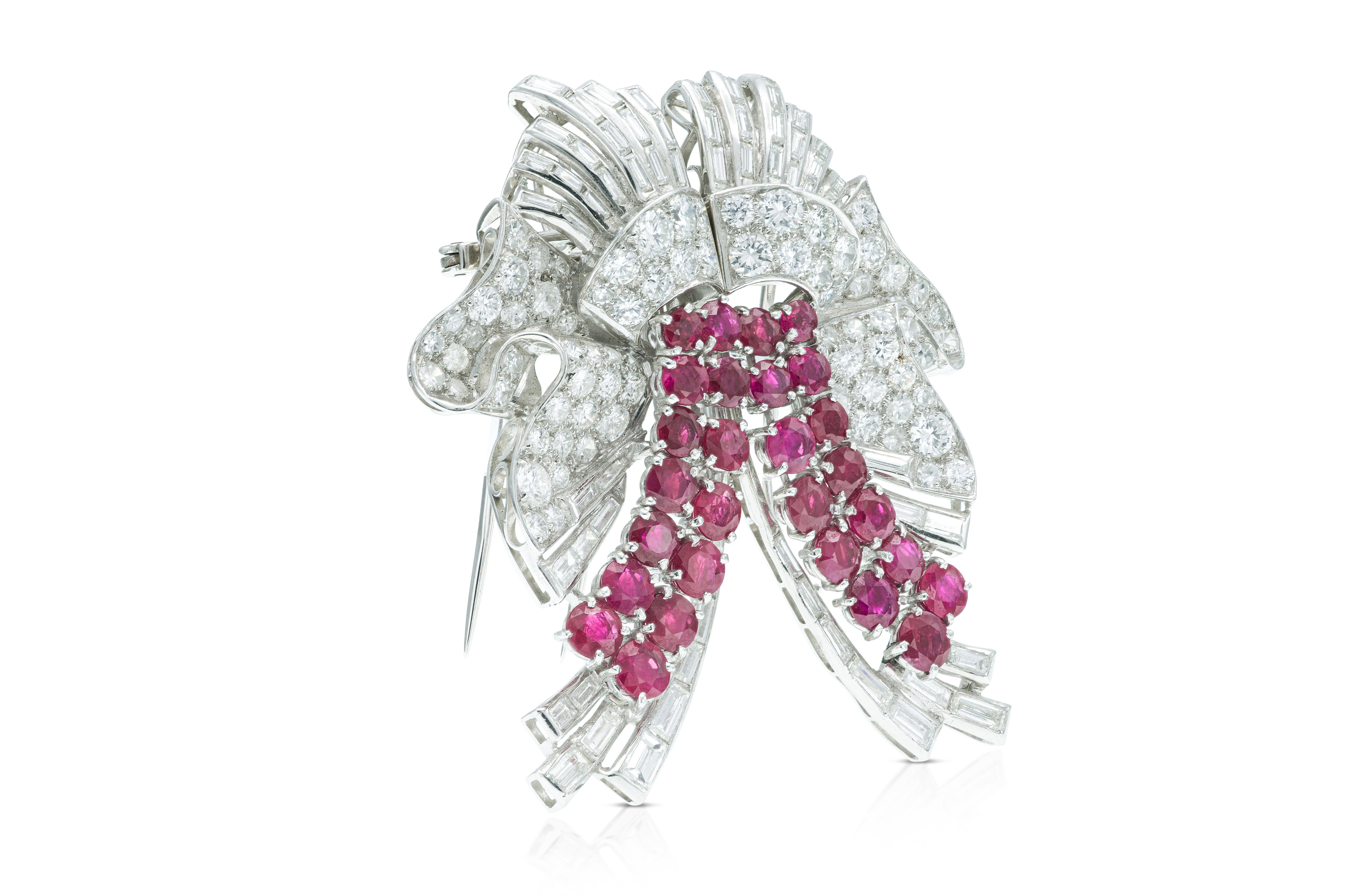 Finely crafted in platinum with Round Brilliant and Baguette cut Diamonds weighing total of approximately 12.00 carats, and Round cut Rubies weighing a total of approximately 9.00 carats.
The brooch separates into two small clips.
Circa 1950s
Brooch