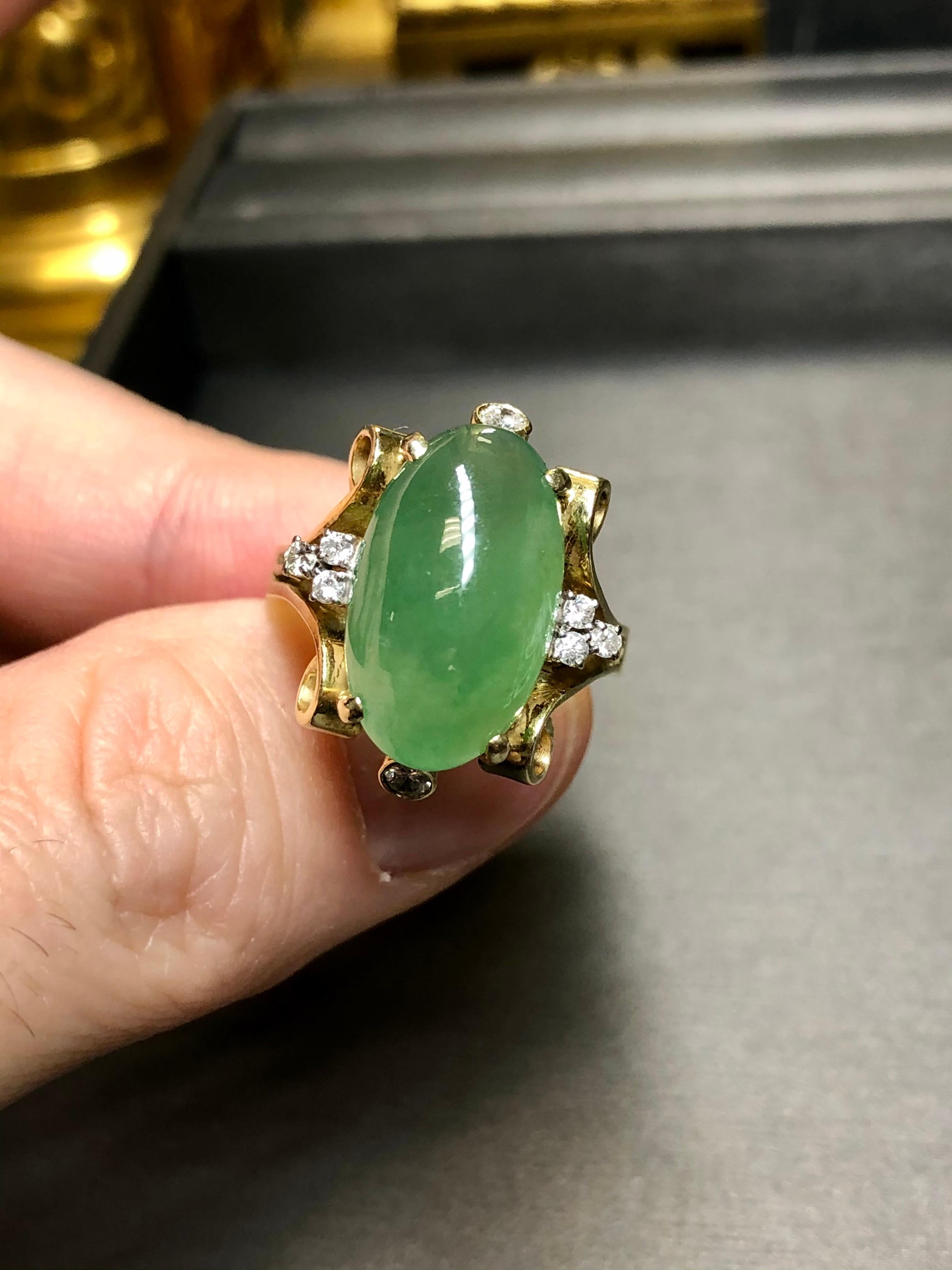 An impressive vintage ring done in 14K yellow gold and centered by an approximately 17ct jade cabochon (17.51mm x 10.65mm x 7.3mm) along with approximately .28cttw in H-J color Si1-2 clarity round diamonds.


Dimensions/Weight:

Ring measures .90”