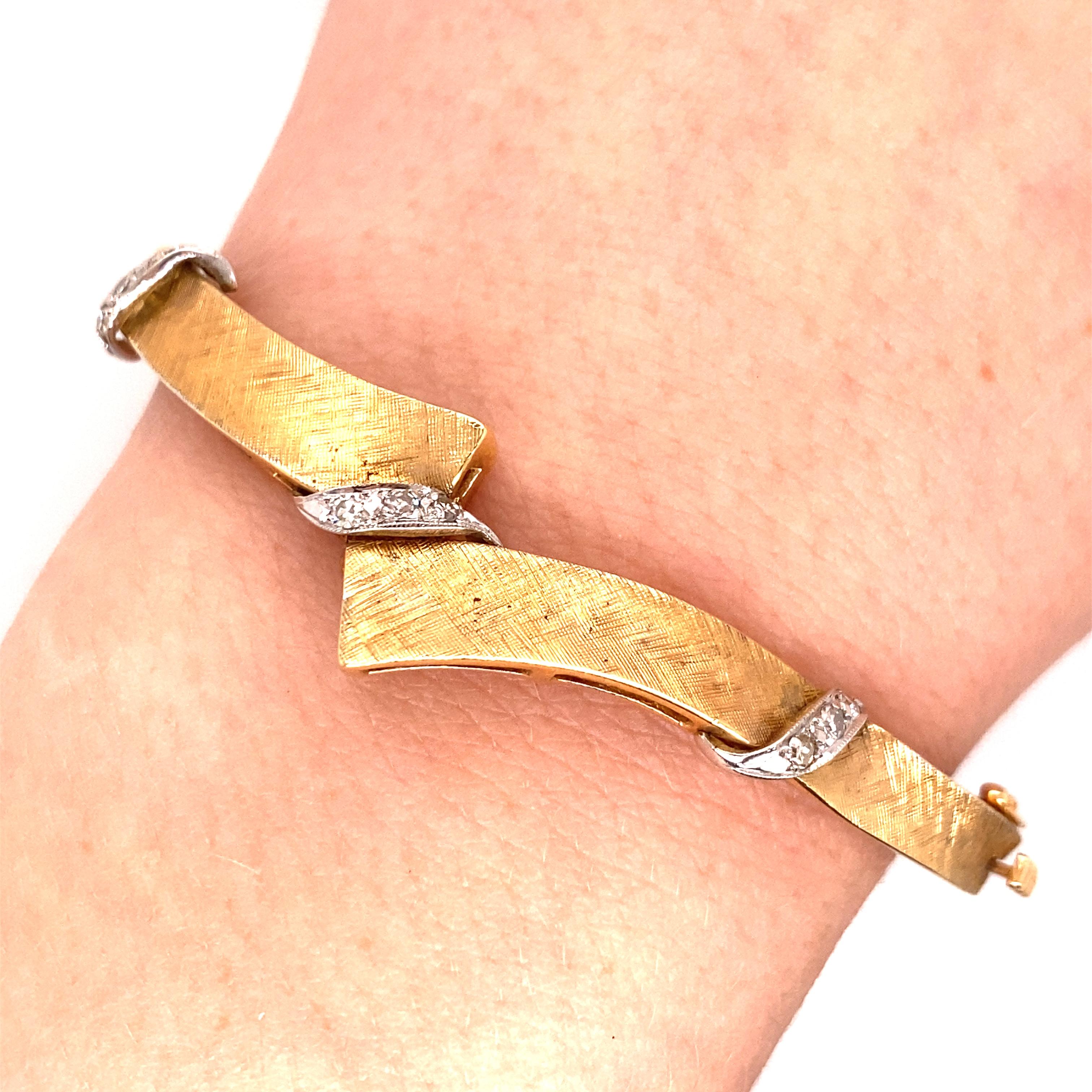 Vintage 1950's 14K Yellow Gold Bangle Bracelet with Diamond Accents - The bangle has a brushed finish with 3 white gold ribbon accents containing 3 single cut diamonds in each. The total weight is approximately .25ct with G - J color and VS clarity.