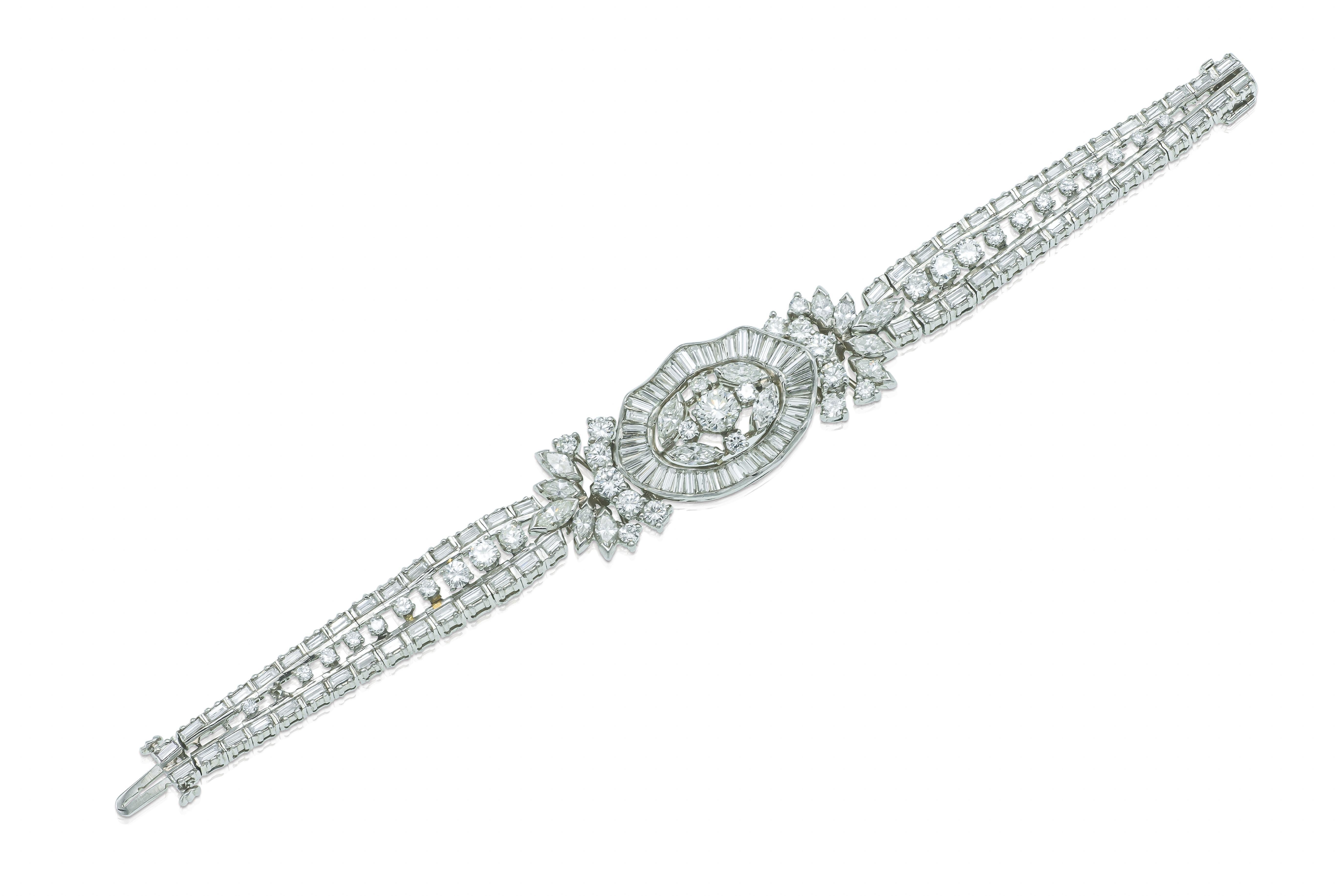 Finely crafted in platinum with Round Brilliant, Baguette, and Marquise cut Diamonds weighing a total of approximately 15.00 carats.
Circa 1950s
Size 6 1/2 inches