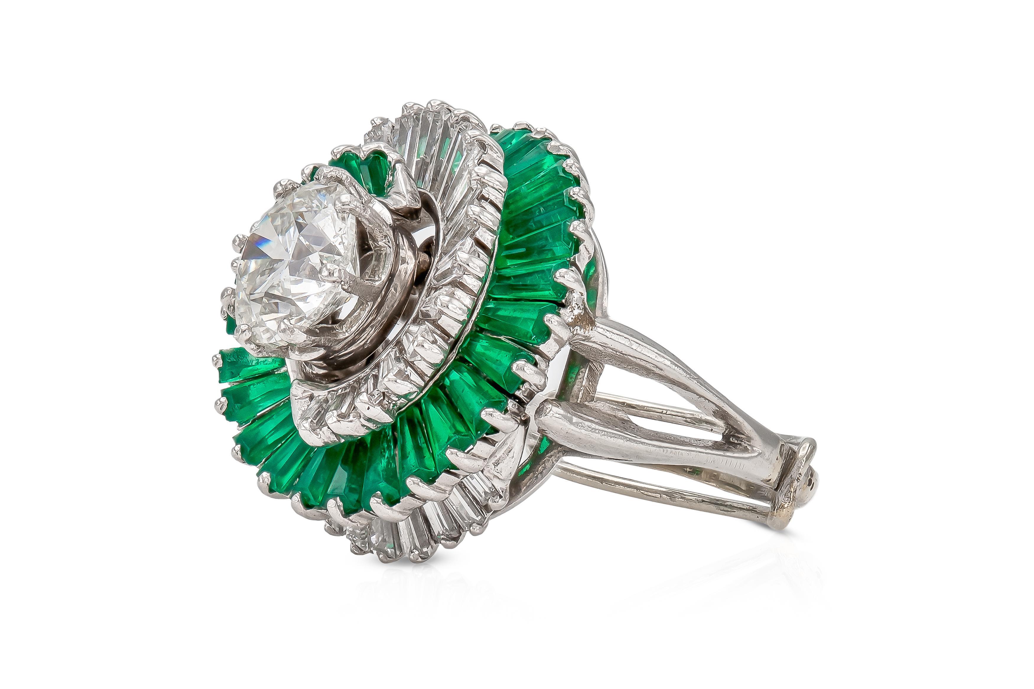 Finely crafted in platinum with a Round Brilliant cut center Diamond weighing 1.52 carats, J color, SI2 clarity.
The Diamond is set in a swirl setting featuring Tapered Baguette cut Emeralds and Diamonds.
Circa 1950s
Size 5 (3 1/2 with guard),