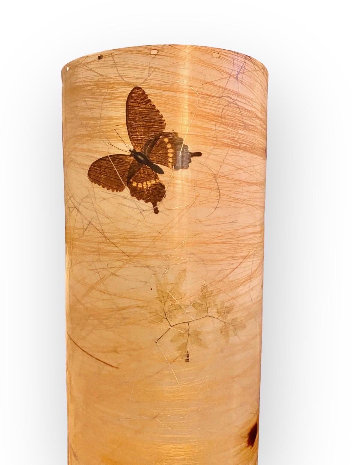 Think warm glow, a mid century modern lantern, accent lamp creating a mood of painterly color with butterflies and leaves pattern. That best describes the artful glow of this illuminated treasure.
A perfect welcoming accent to any kitchen, dining or