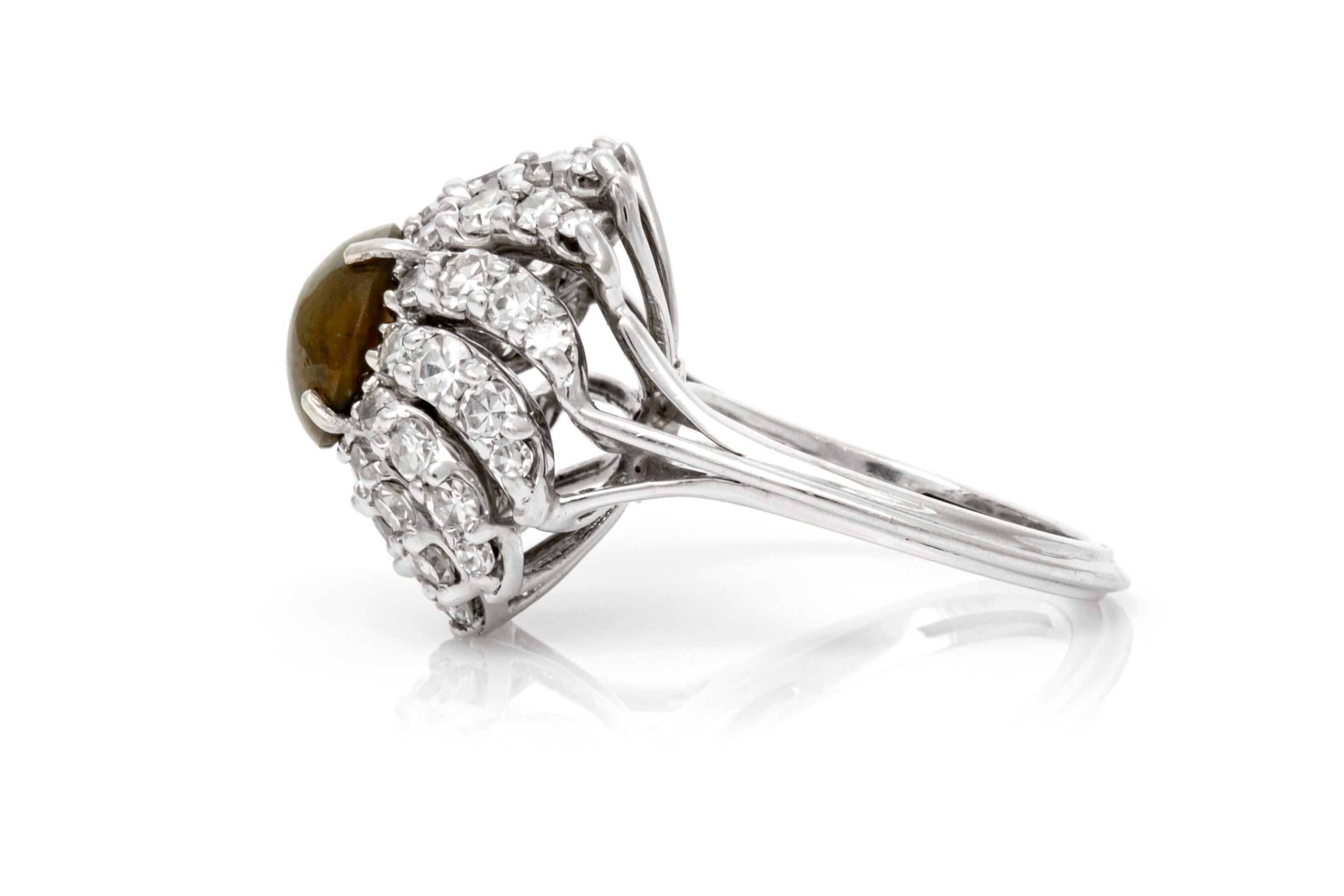 Finely crafted in platinum with a center Cabochon Cat's Eye weighing approximately 2.50 carats and surrounding Single cut Diamonds weighing a total of approximately 2.00 carats.
H-I color, VS1-VS2 clarity
Circa 1950s
Size 7, resizable