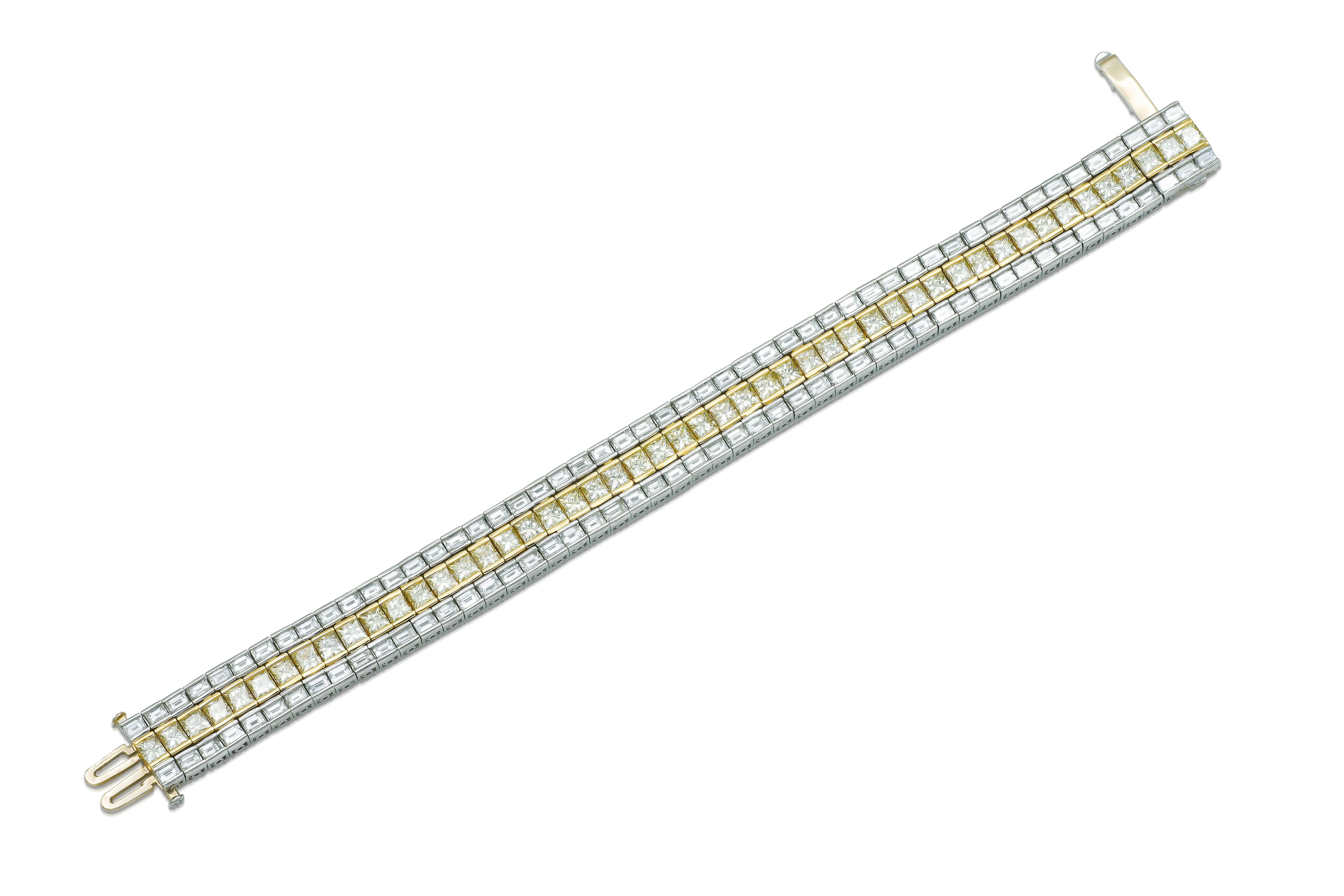Finely crafted in platinum and 18k yellow gold with 49 Princess cut Yellow Diamonds weighing approximately a total of 17.20 carats, and 102 Baguette cut Diamonds weighing approximately a total of 20.50 carats.
Circa 1950s
Size 6 3/4 inches
1/2 inch