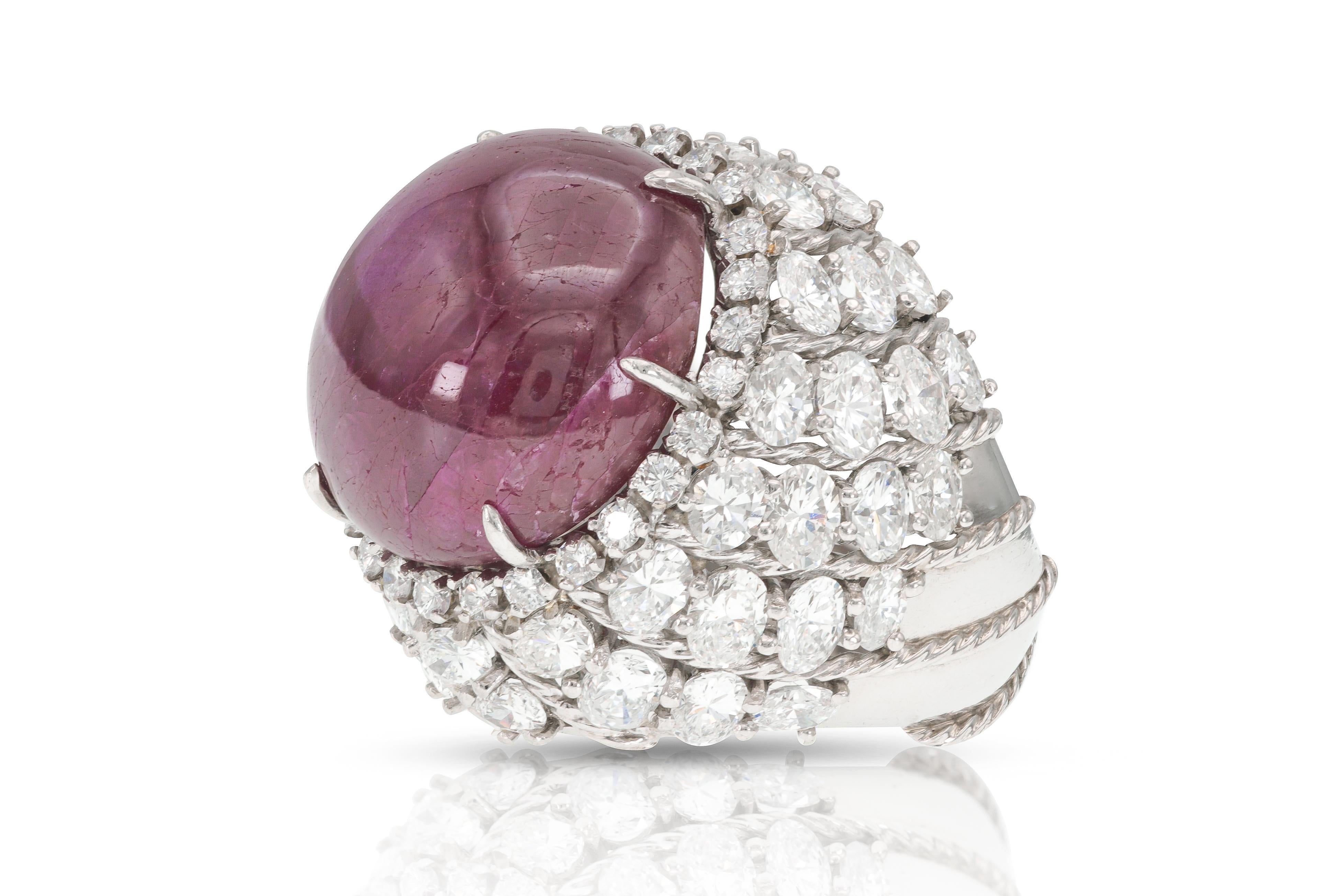 Finely crafted in platinum with a GIA certified Burma origin non-heat treated Cabochon Star Ruby weighing 40.73 carats, GIA #1142496707.
The ring features Oval and Round Brilliant cut Diamonds weighing approximately a total of 13.00 carats.
Circa