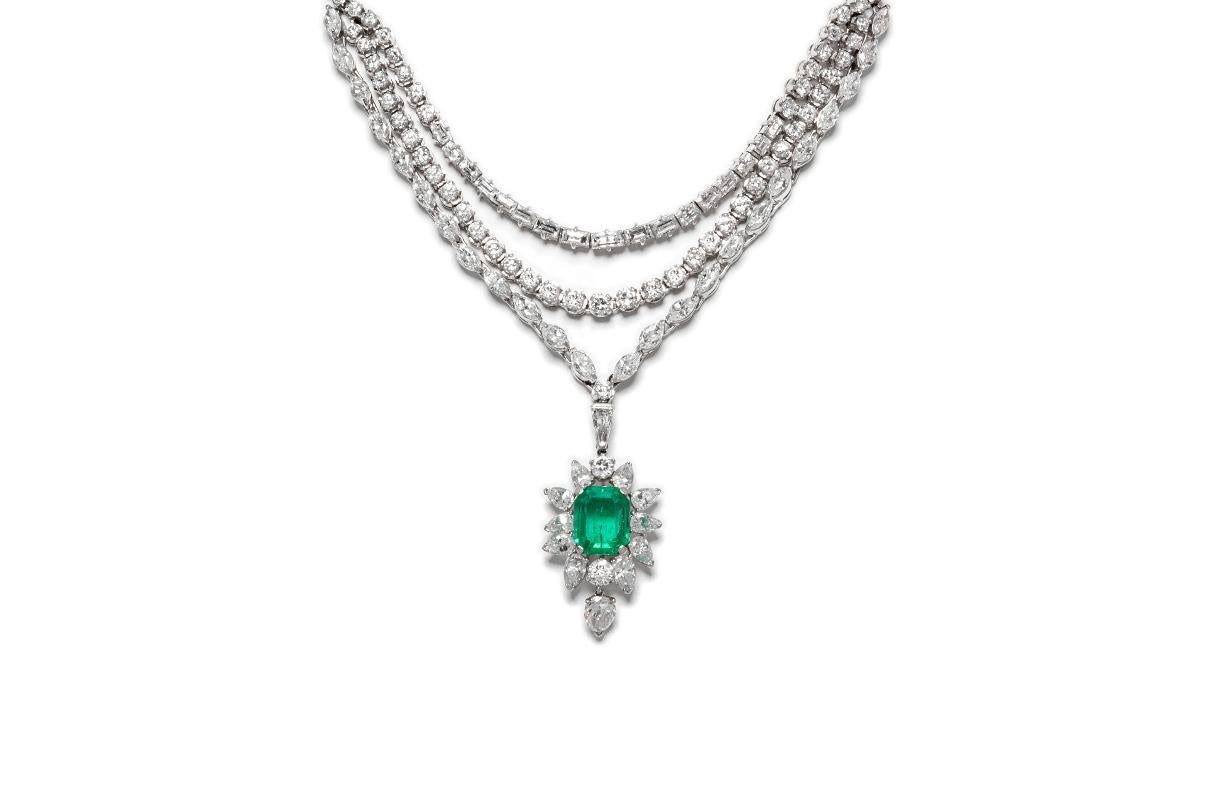 Finely crafted in platinum featuring a center Emerald cut Emerald drop weighing approximately 5.00 carats with Baguette, Marquise, and Round Brilliant cut Diamonds weighing a total of approximately 22.00 carats, G-H color, VS1-VS2 clarity.
Circa