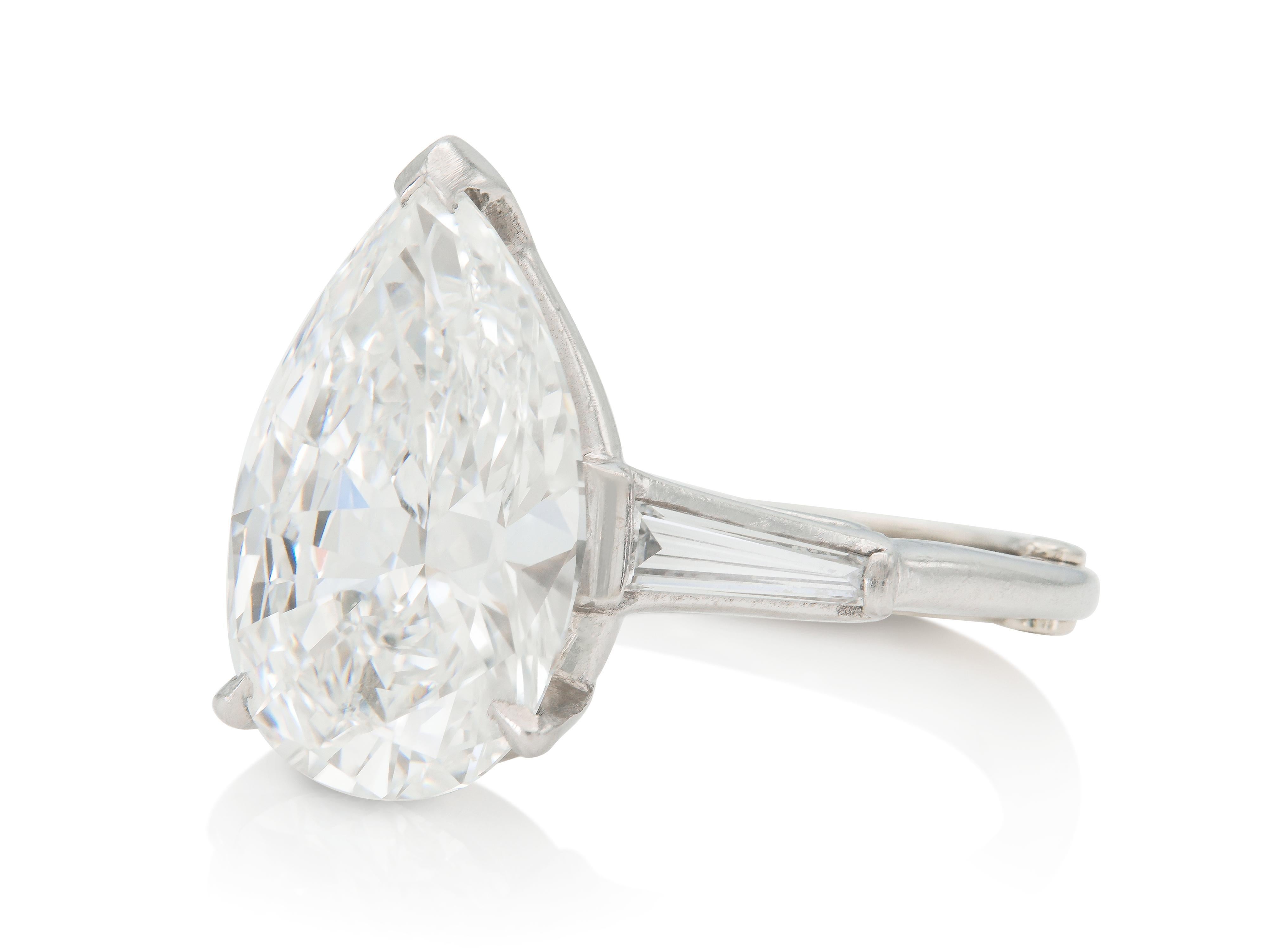 Finely crafted in platinum with a GIA certified Pear-Shaped Diamond weighing 6.38 carats, G color, IF clarity GIA #5181753815.
The ring features 2 accenting Tapered Baguette cut Diamonds.
Size 6 3/4, resizable