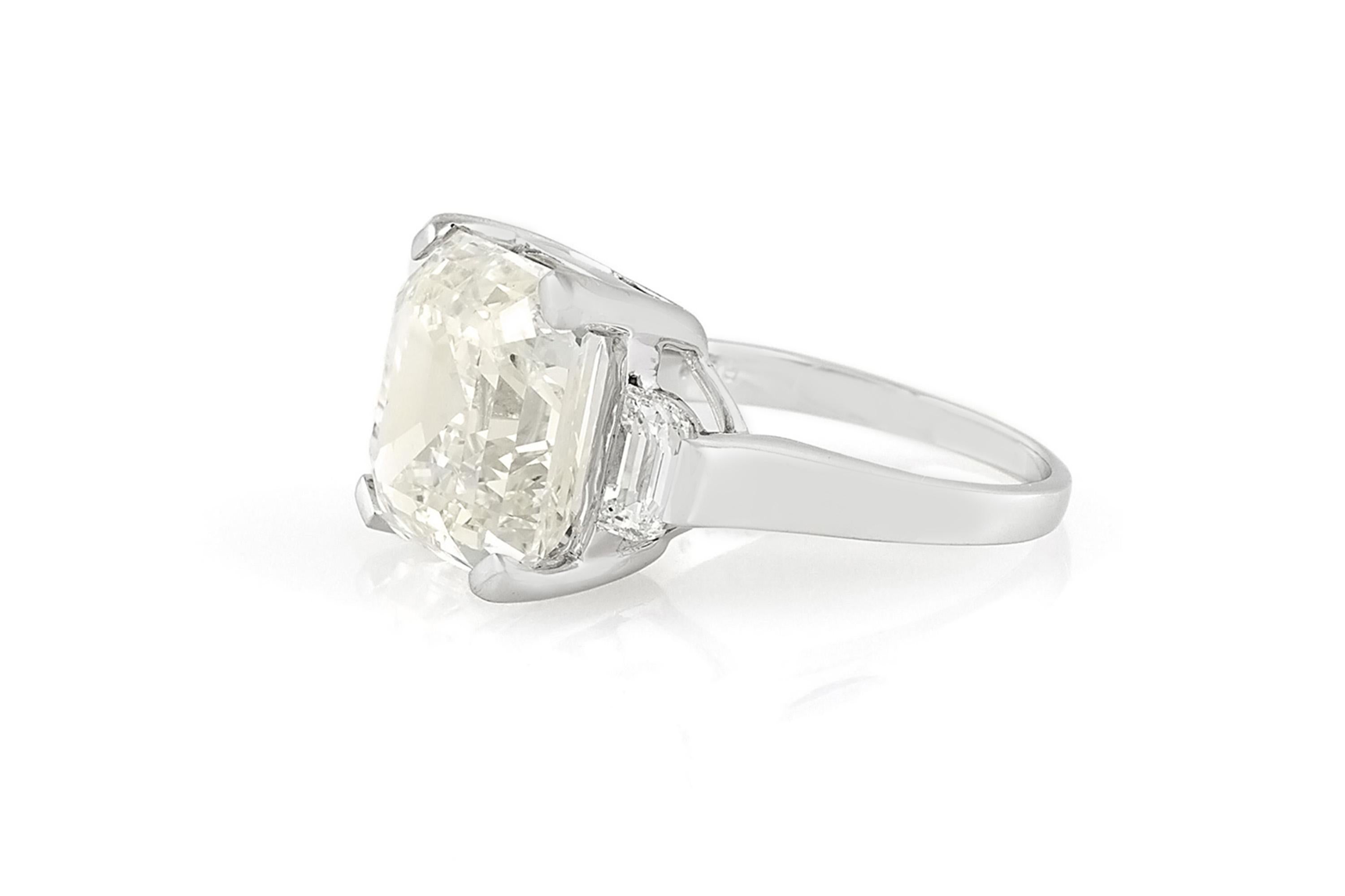 Finely crafted in 18k white gold with an Asscher cut center Diamond weighing 9.47 carats, L color, SI1 clarity.
The ring features 2 Half-Moon cut side Diamonds weighing a total of 0.89 carat.
Circa 1950s
Size 6 3/4, resizable