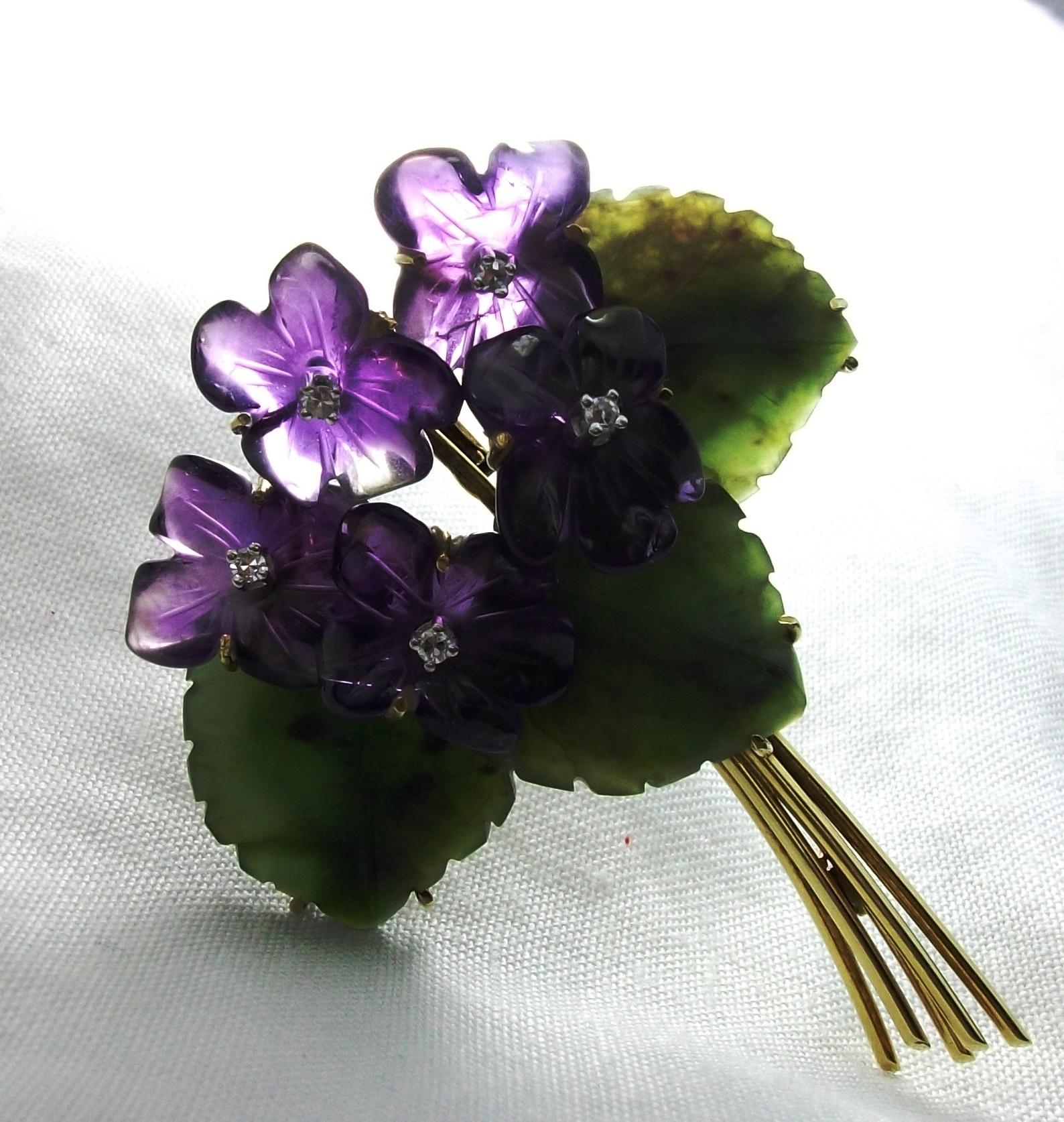 This is a more than wonderful 14k gold mounted brooch in a shape of a romantic and sweet bouquet of violets,  entirely handmade. Violets are made of amethyst with  diamonds in each one. The leaves have shiny edges and are made of jade. This brooch