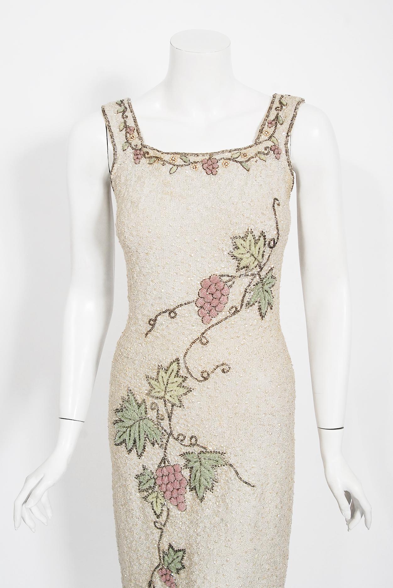 This is an incredible late 1950's Saks Fifth Avenue hand-knit ivory cocktail that is completely covered in iridescent sequins & sparkling beadwork. The textured stretch knit has a way of hugging the body that is infinitely flattering. The sleeveless