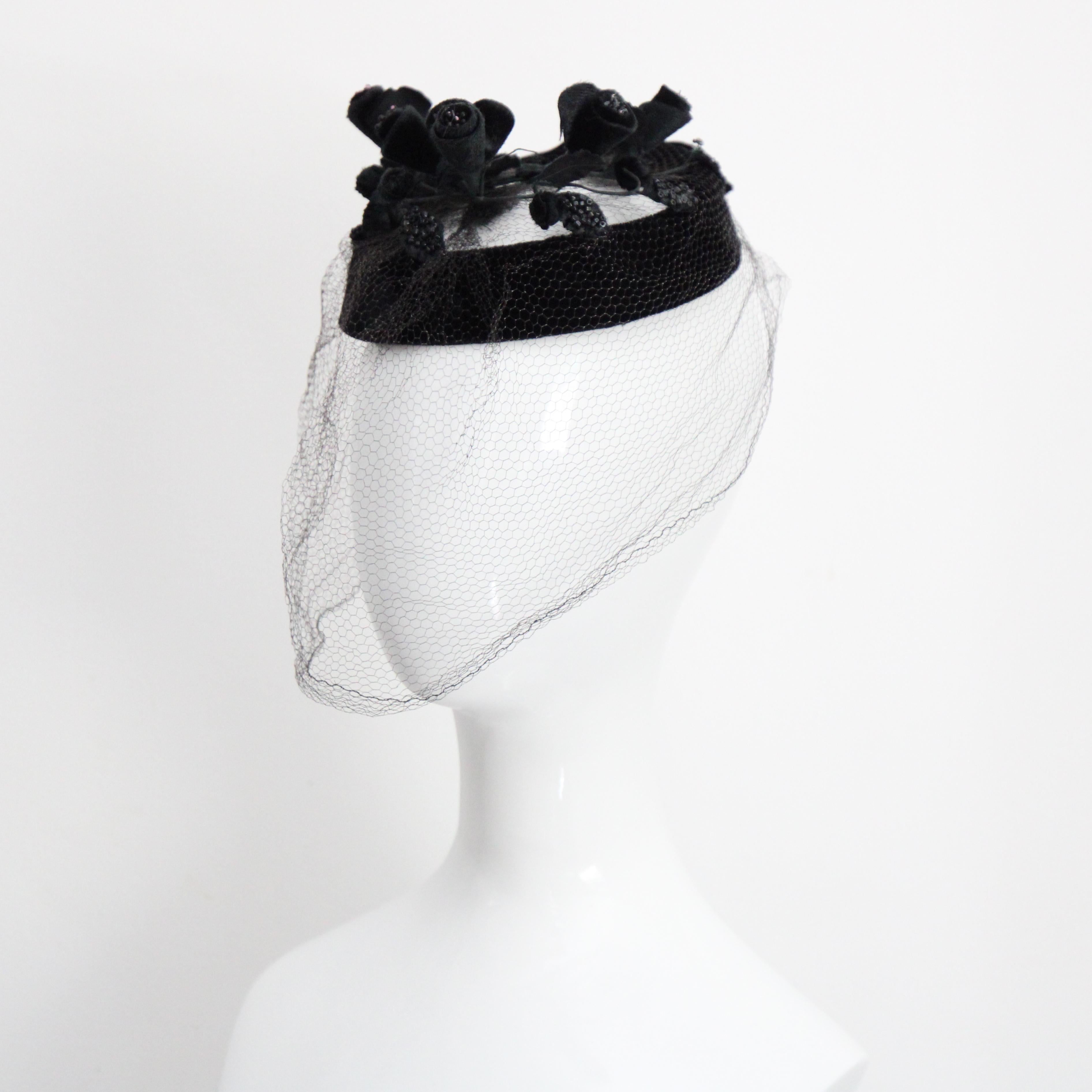 This truly eye-catching 1950's halo hat, rendered in a sumptuous black velvet, is the perfect statement piece to your millinery collection. 
  
The rounded halo base of the hat, showcases an open design and is finished in black velvet. The open