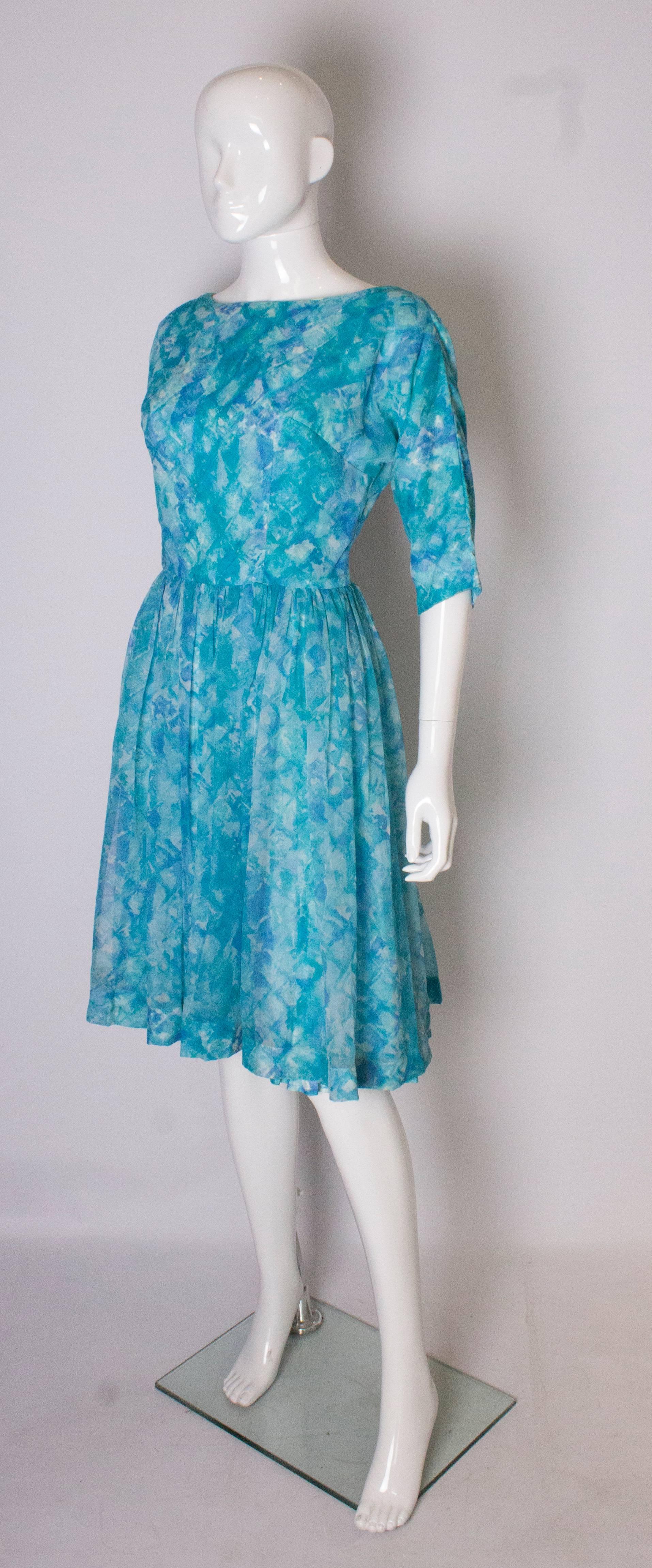 Blue A Vintage 1950s classic swing cinch cocktail dress with pleated skirt