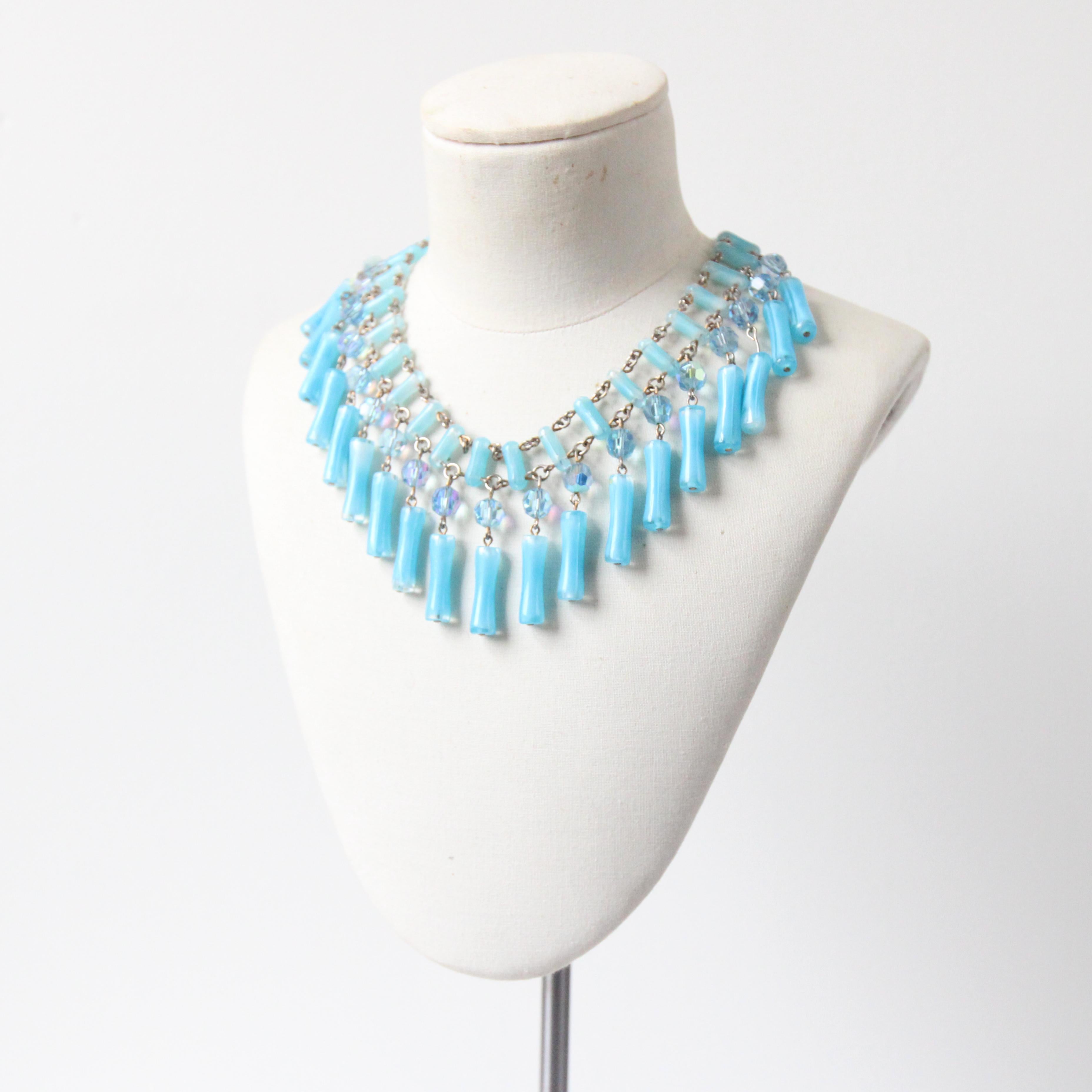 This truly eye-catching 1950's necklace, constructed on a silver toned metal link chain, upon which aqua blue glass beads are threaded between the links, creating a double strand feature, is the perfect statement piece to your jewellery collection.