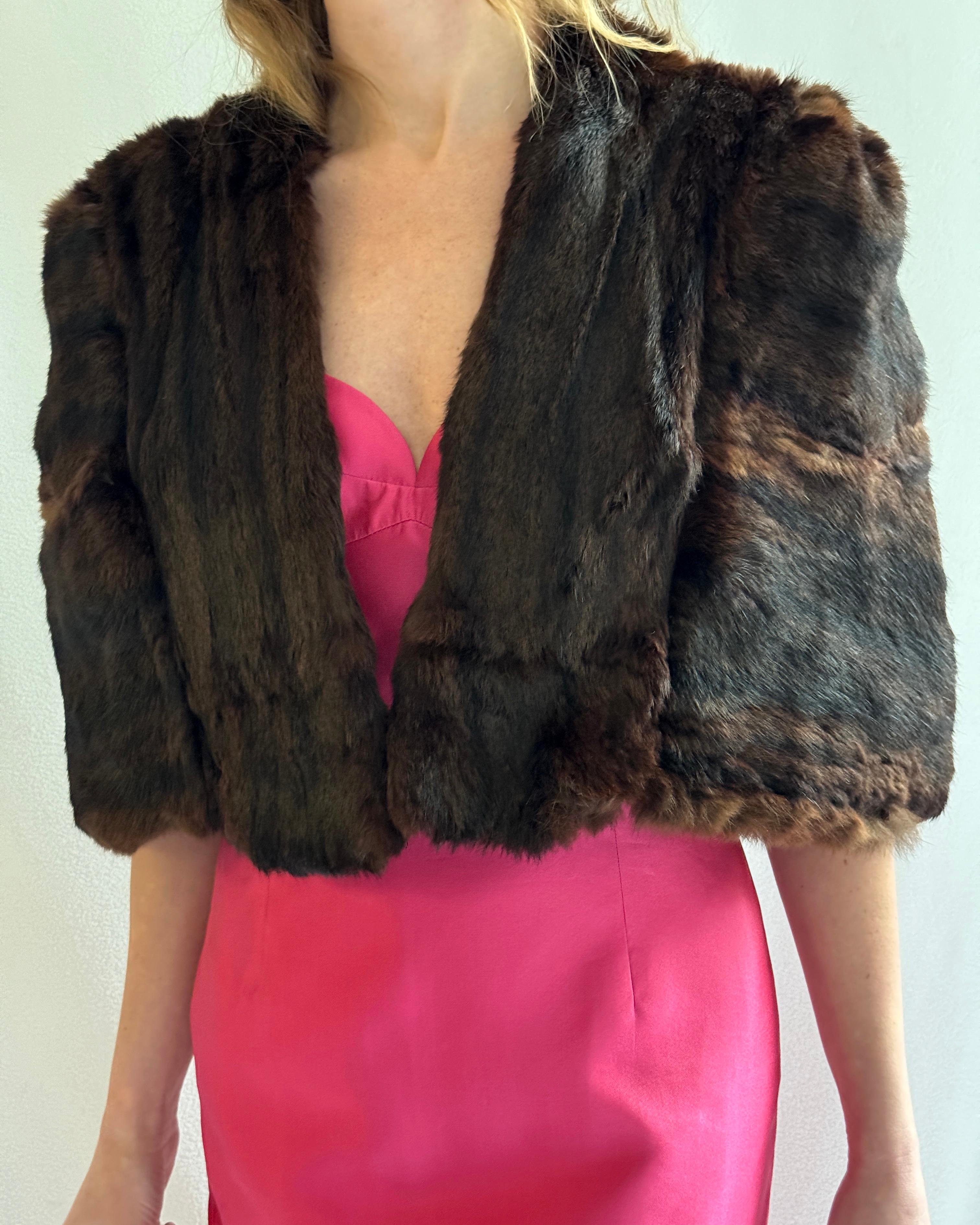 This is the ultimate vintage fur cape. Circa 1950s, its silhouette is simple enough but the construction is deceptively complex, creating the perfect shape. Although it's a cape and there are no sleeves, the way it's sculpted through the shoulders