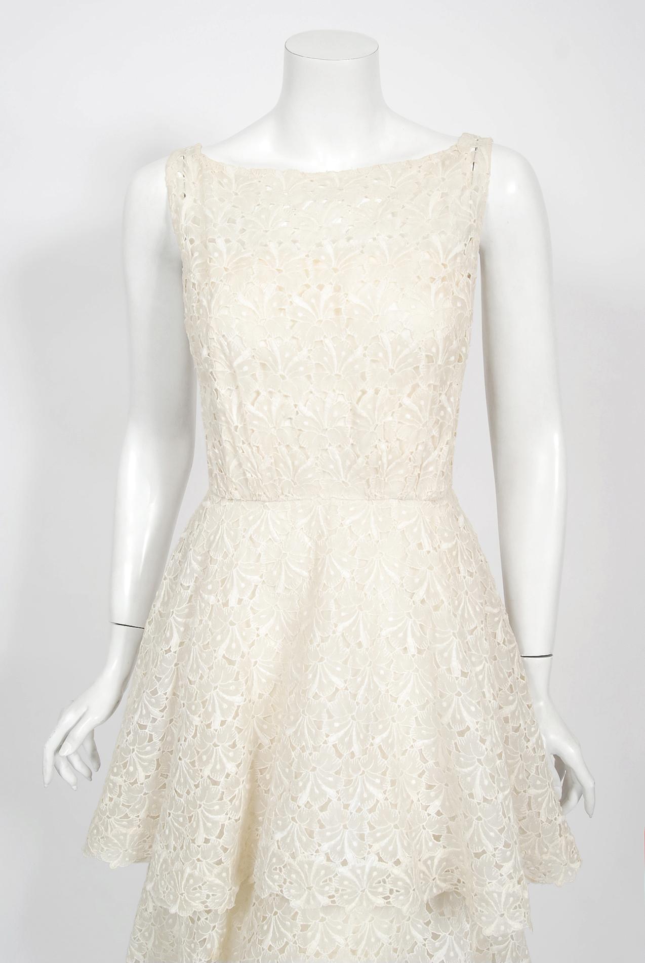 An absolutely stunning Ceil Chapman designer ivory embroidered cotton eyelet dress dating back to the late 1950's. Perfect for any upcoming summer event; you can't help but feel ethereal in this beauty! I love the slight blousy nipped waist bodice