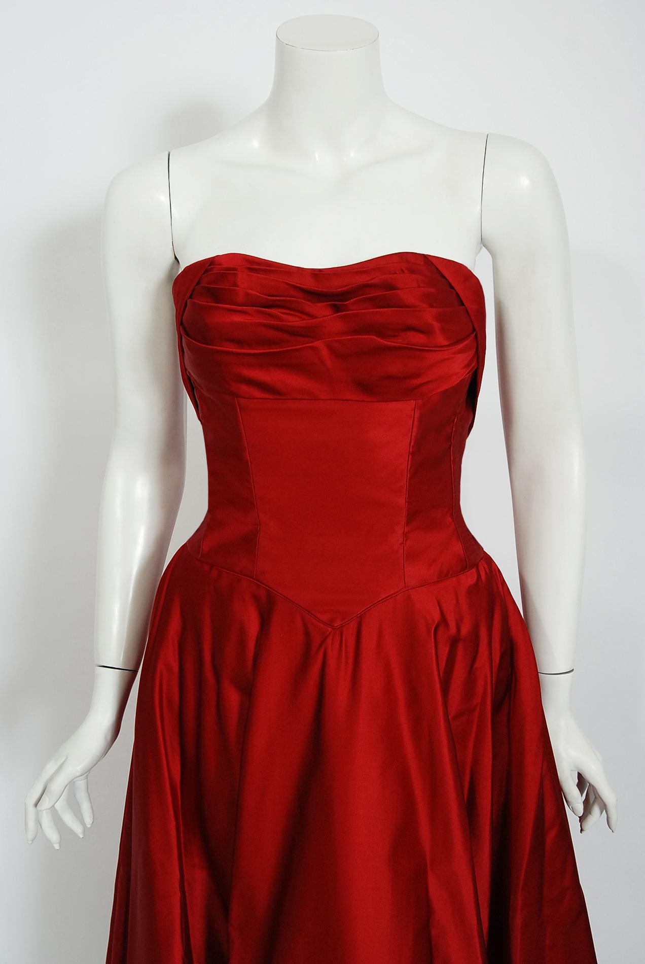 This is such a seductive and dramatic formal gown from the iconic 1950's Ceil Chapman designer label. Perfect for any upcoming holiday event; you can't help but feel feminine in this beauty! The garment is fashioned from luxurious mid-weight silk