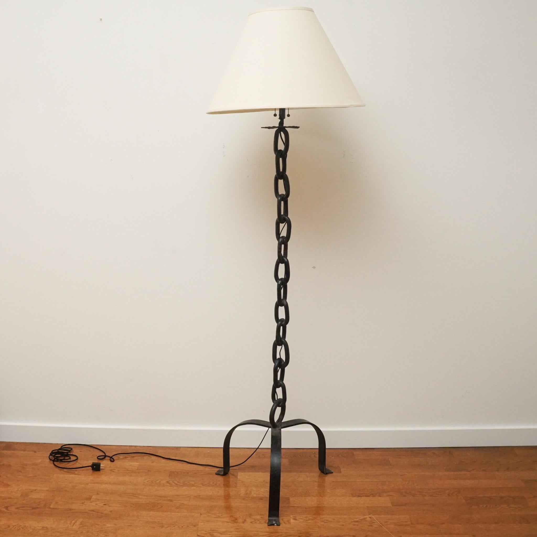 This vintage chain floor lamp was discovered during a Paris buying trip. Made in the 1950s, the vertical welded iron chain links are supported with a tri-pod iron base. The lamp has been rewired and fitted with a two-bulb fixture for maximum light.