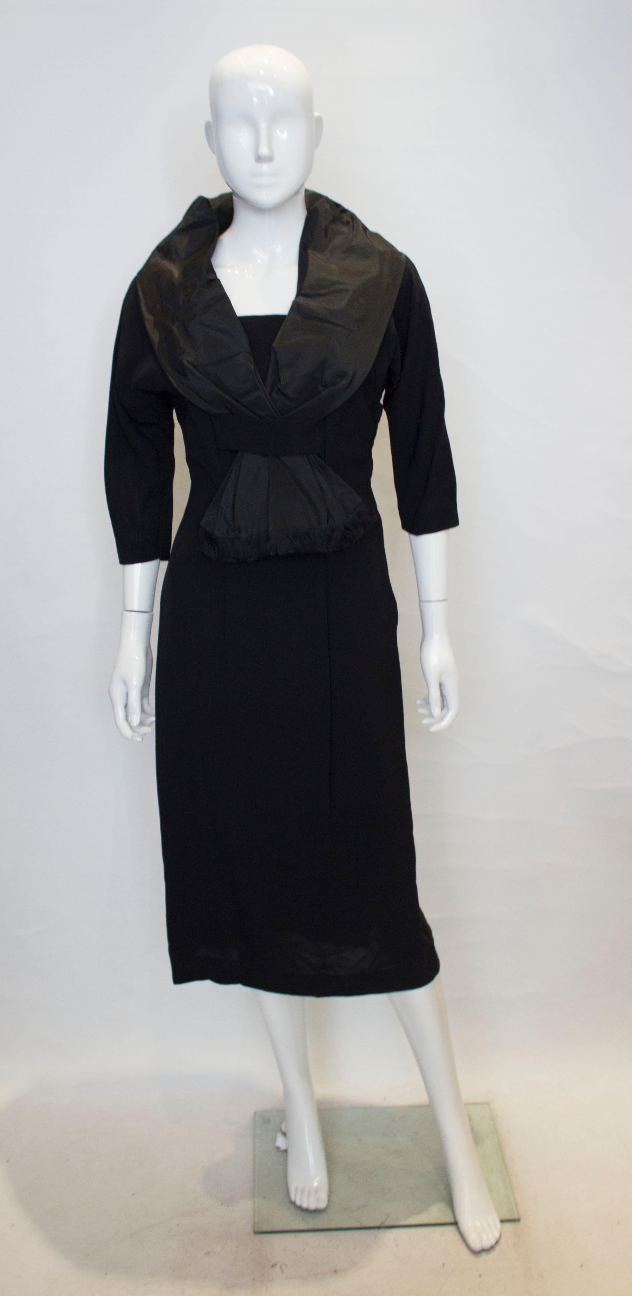 A chic vintage cocktail dress with shawl collar with fringe detail .
The dress has wonderful tailoring and opens with a side zip, and is fully lined.