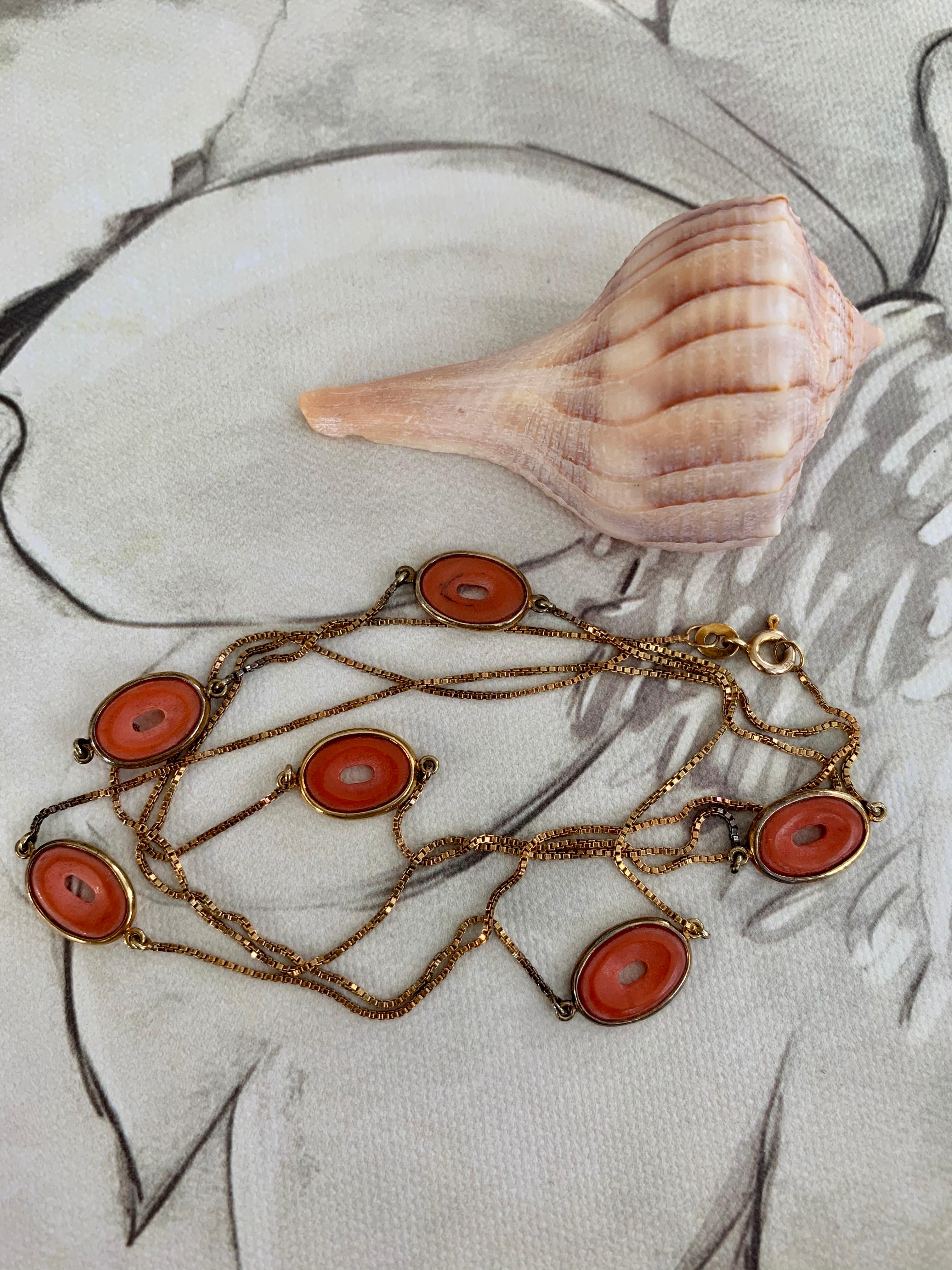 This beautiful vintage necklace is right out of the 1950's.  The links of the necklace are made from disc-shaped pieces of Coral.  The Coral, and the design, are absolutely gorgeous.  

The chain is 34