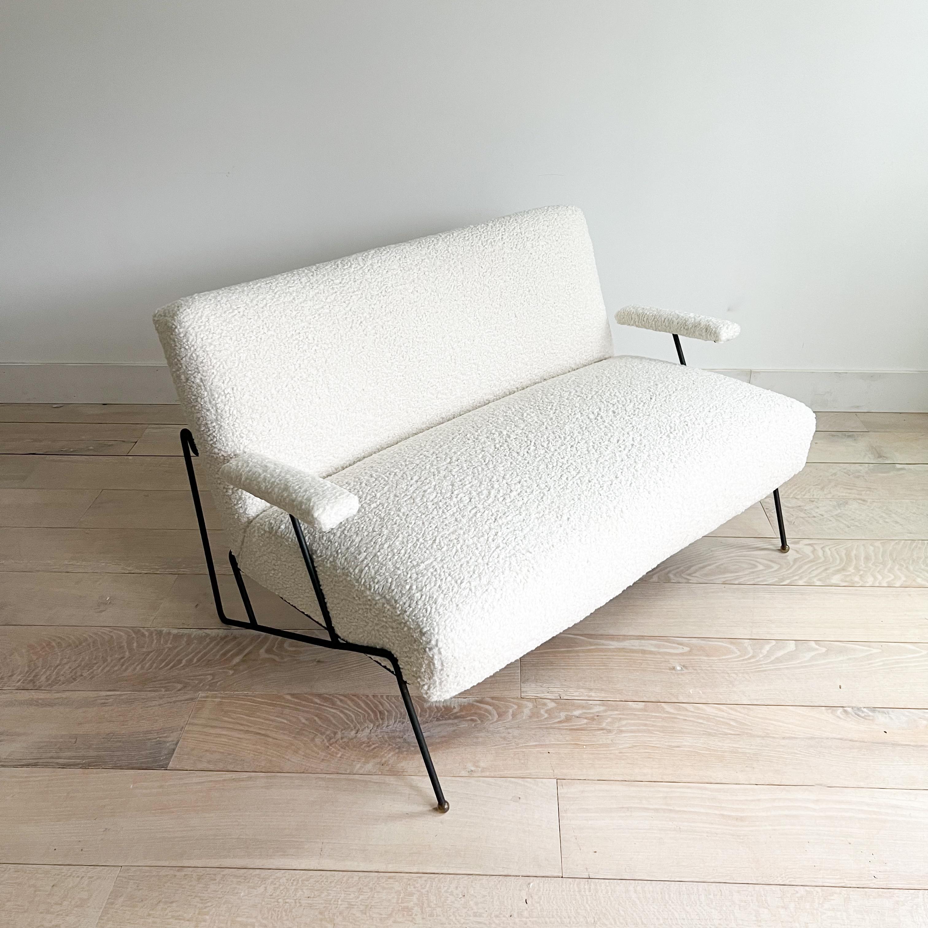 Elevate your home with this rare loveseat/settee, a masterpiece of mid-century design by Dan Johnson and meticulously crafted by Pacific Iron in the USA during the 1950s. Boasting a sleek iron frame with subtle wear that adds to its vintage charm,