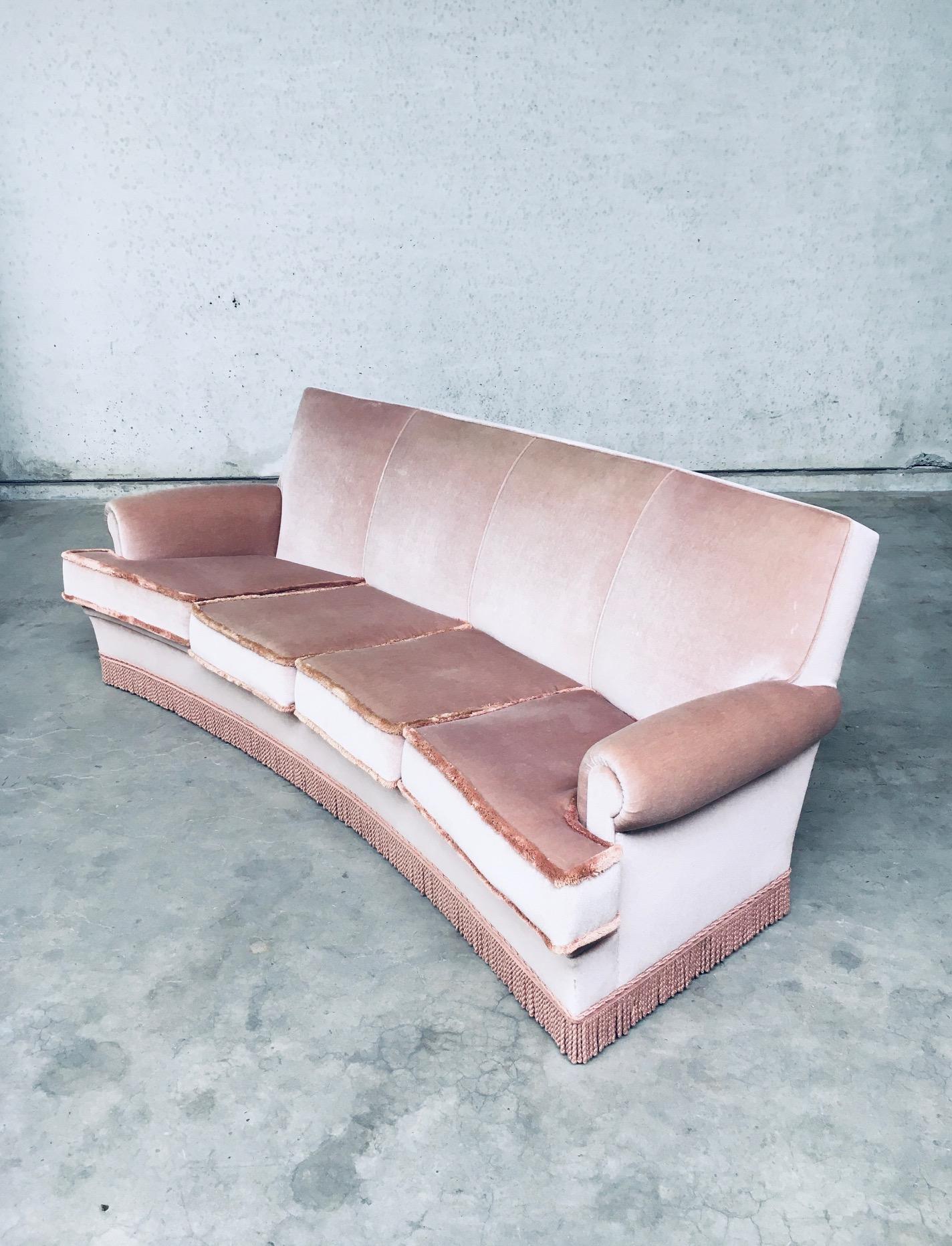 Vintage Midcentuy Design in the style of Art Deco Pink Velvet Curved 4 Seat Sofa with Fringe, made in Belgium 1950's. Large model sofa in soft pink color. In very good, hardly ever used condition. Measures 92cm x 240cm x 100cm.
