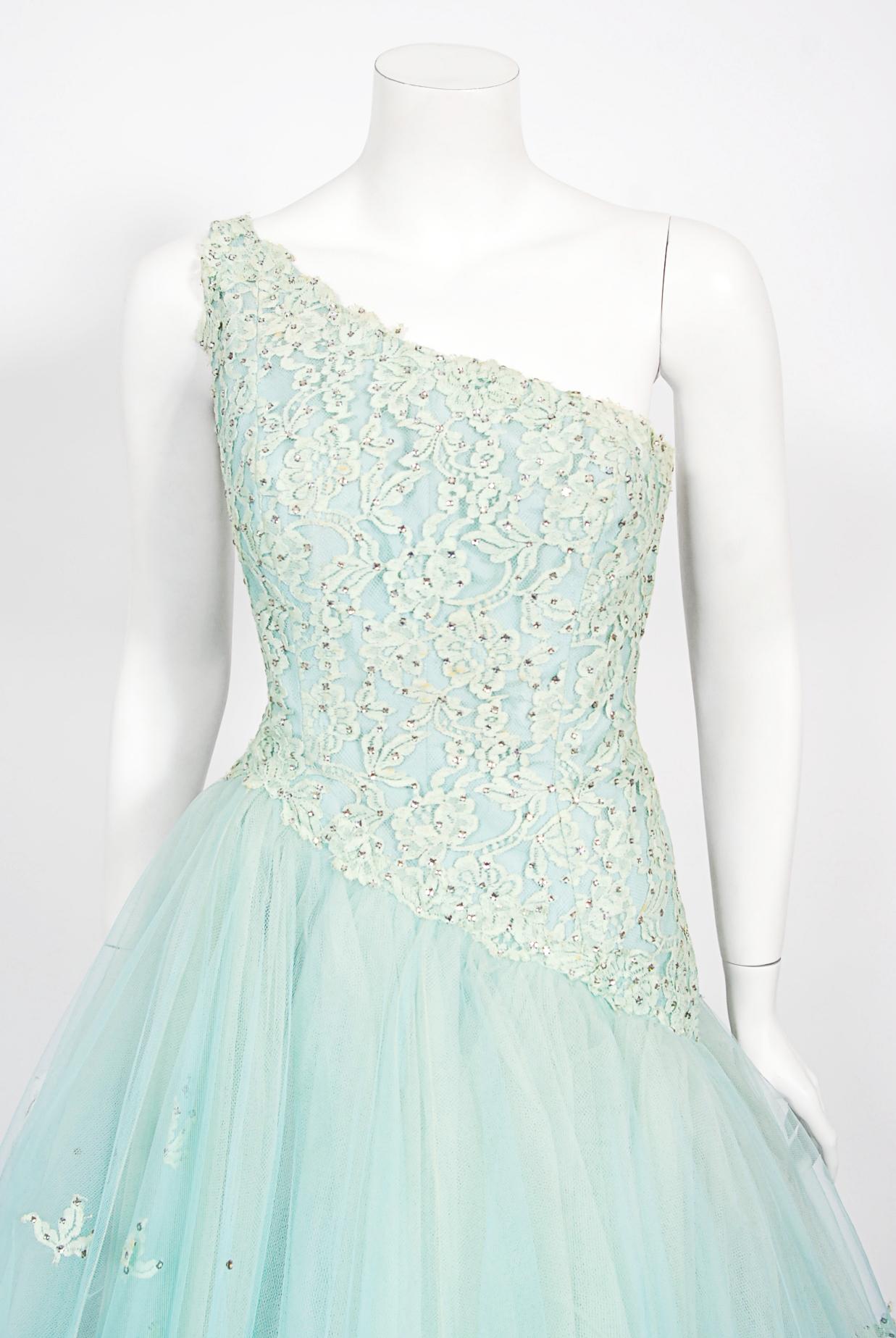An absolutely gorgeous early 1950's sparkling seafoam blue rhinestone lace and sheer tulle ballerina-length dress by Edith Small. Although originally from Chicago, in 1945 Edith Small opened her clothing house in Los Angeles, California. Small was
