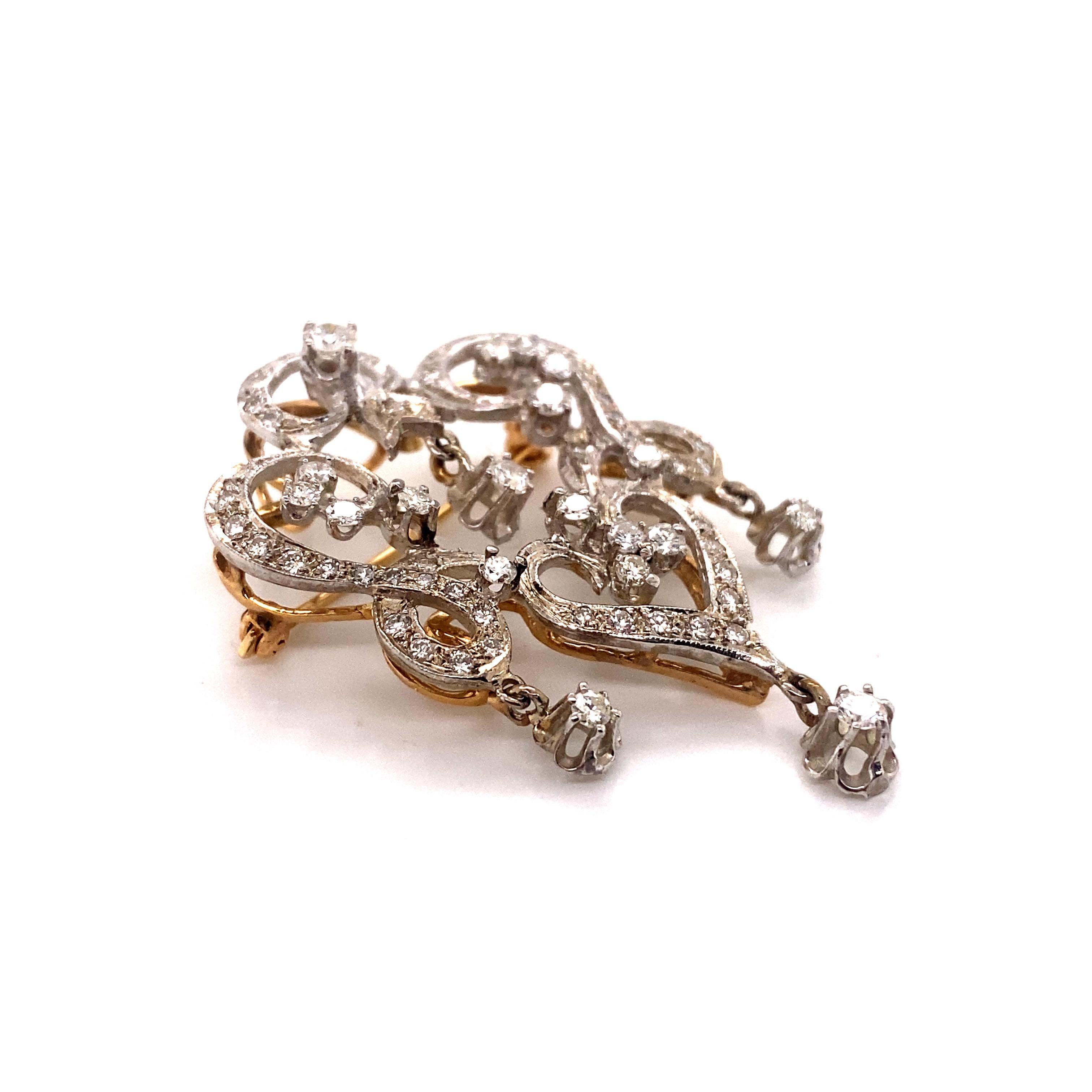 Vintage 1950’s Edwardian Reproduction Diamond Chandelier Brooch and Pendant. The brooch contains 19 larger round diamonds set in 4 prong heads and 6 prong tulip dangling heads and weigh approximately .75ct total weight. There are an additional 53