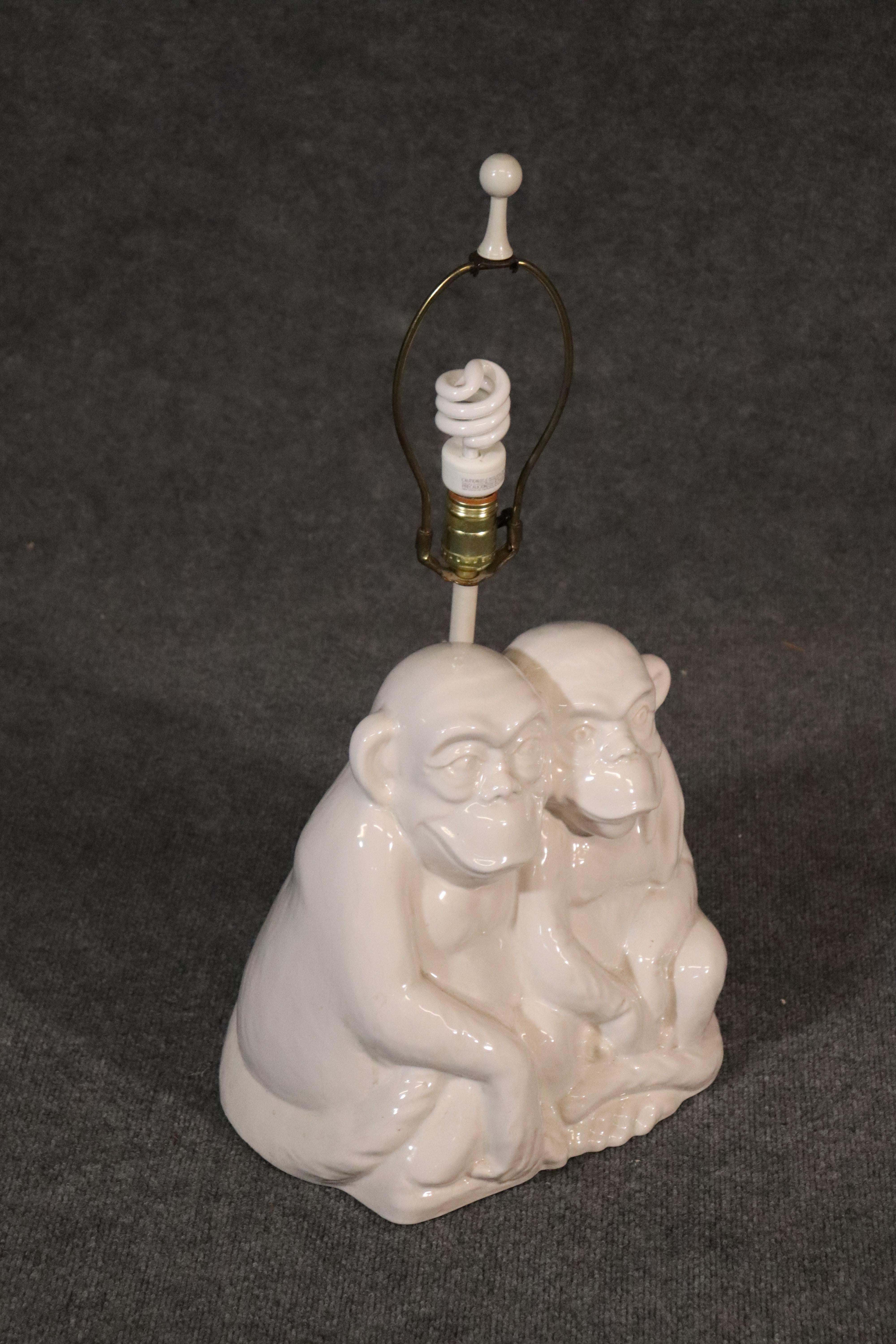 This vintage 1950s era lamp depicts two monkeys hugging each other. The lamp is in fundamentally good condition with hairline stress cracks on the back. The lamp is still completely usable and can be used every day. Measures 26.5 tall x 14 wide x 9