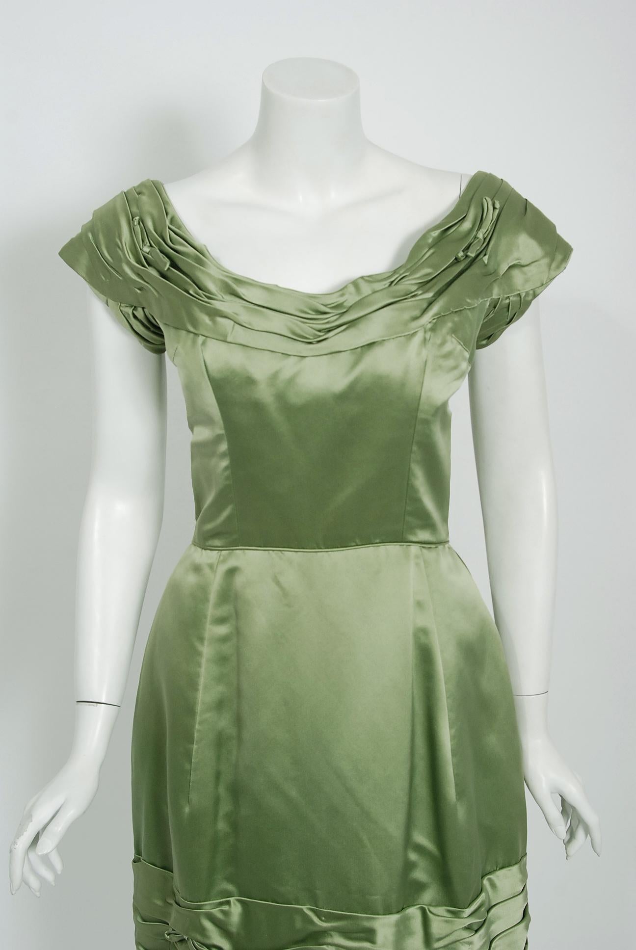 Such an elegant and timeless 1950's cocktail dress from the Evelyn Brown Washington D.C designer label. Perfect for any upcoming party; you can't help but feel feminine in this beauty! The garment is fashioned from a stunning mid-weight lined sage