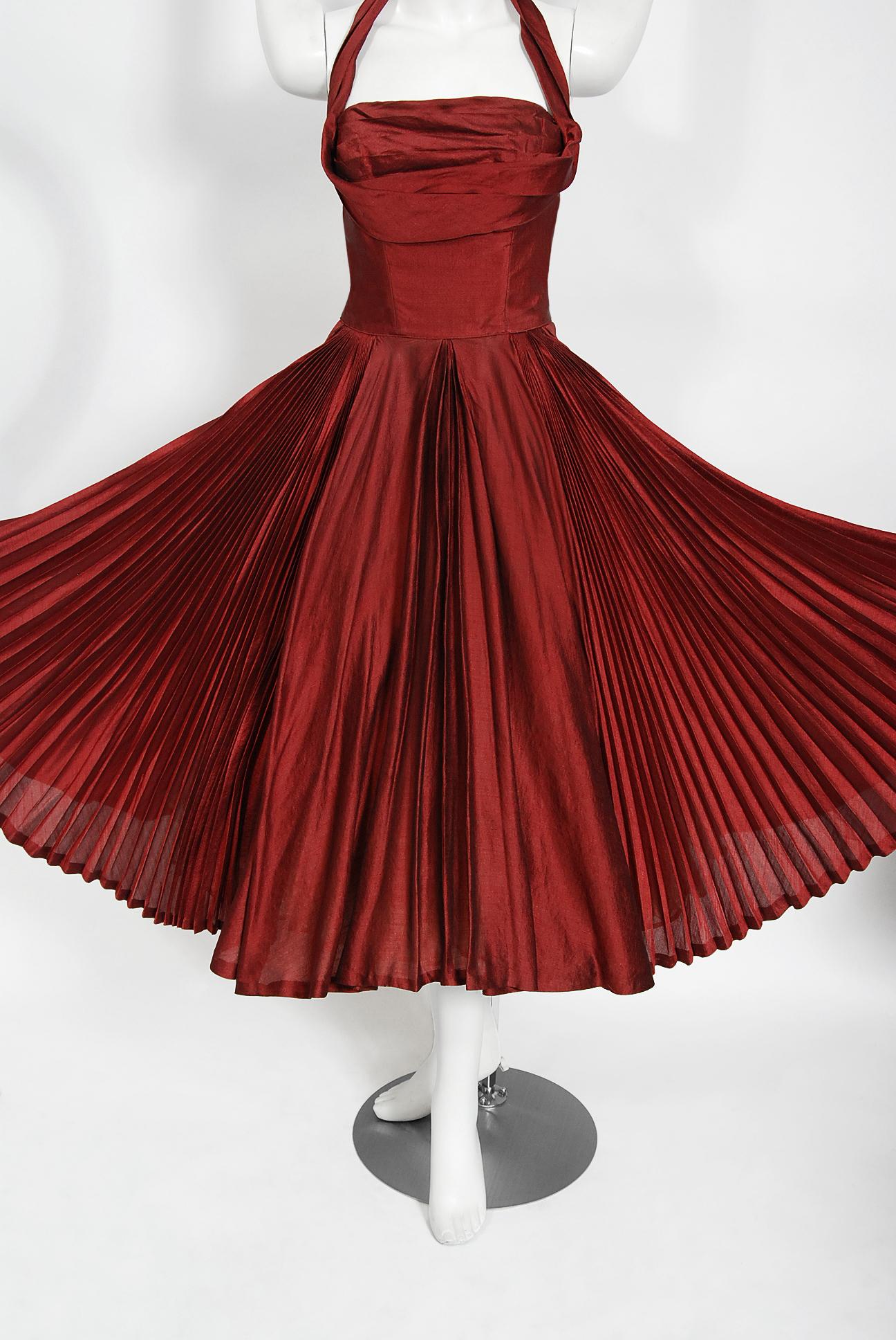 A magnificent 1950's creation by the iconic dress designer Fred Perlberg.  This gorgeous garment is fashioned from  light-weight shimmering silk organza in the most spectacular merlot red color. The bodice is an alluring low-cut halter with the