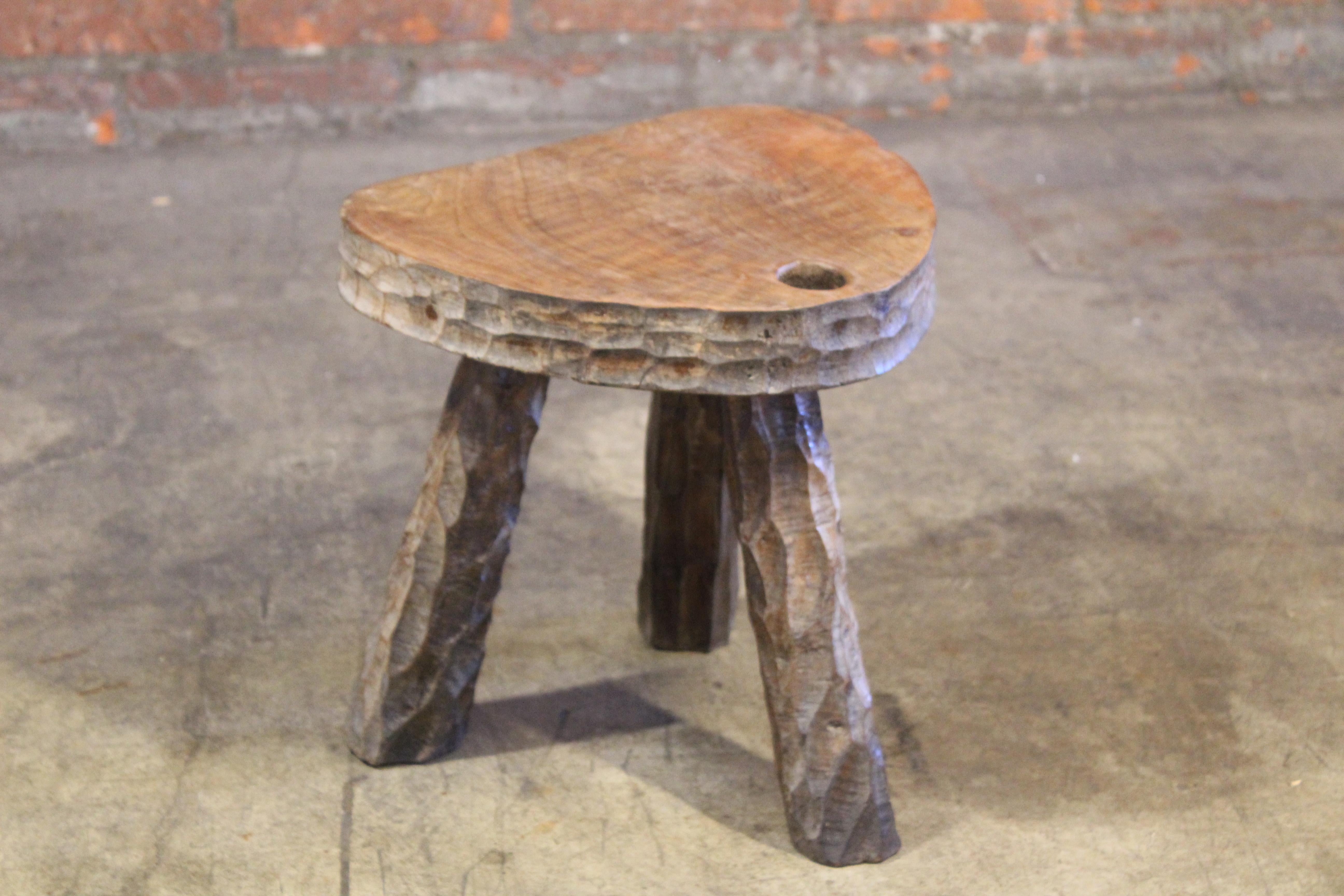 A vintage solid gauged oak three leg stool in the manner of Jean Touret, France, 1950s.