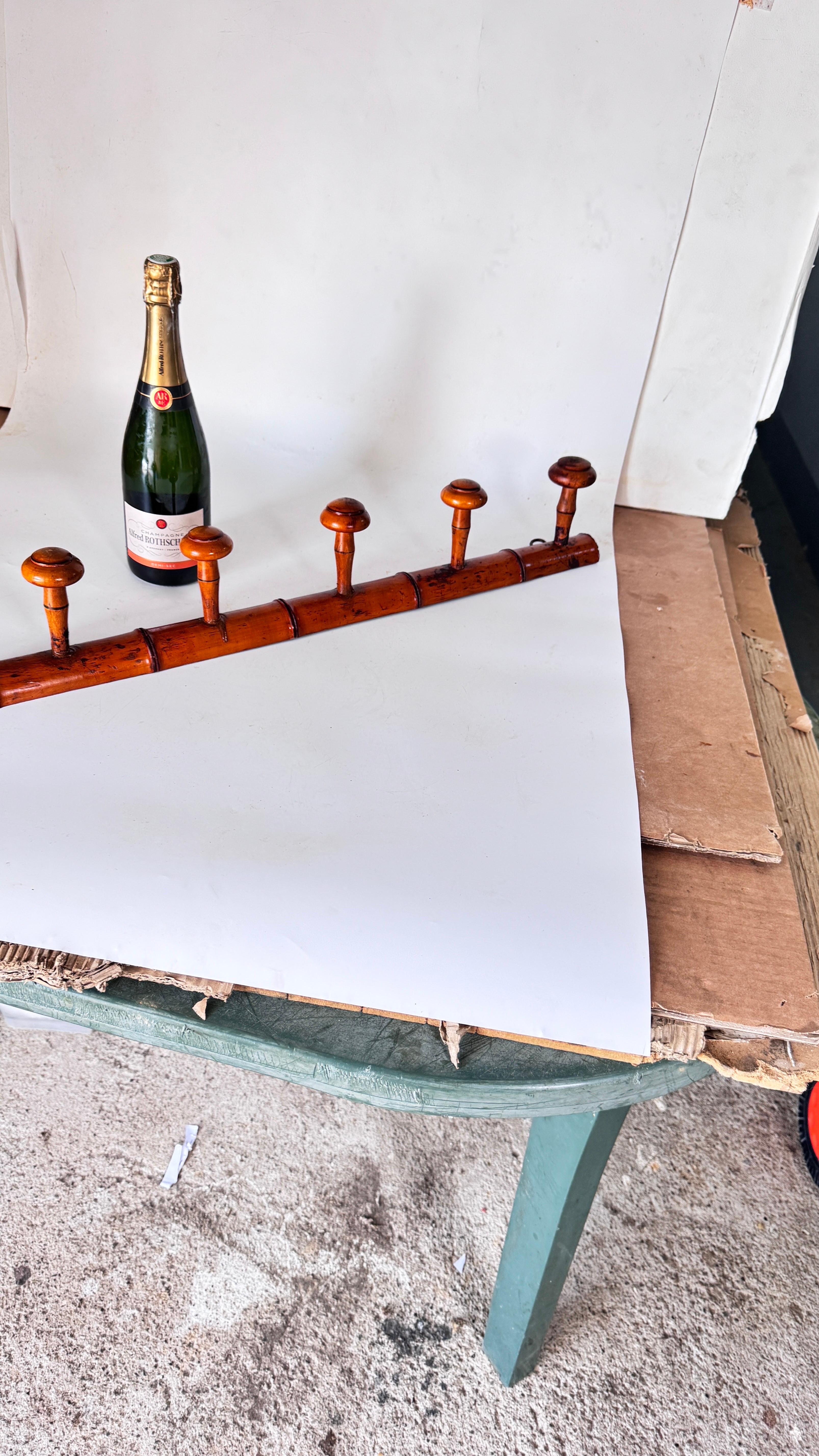 Vintage 1950s French Coat Rack, Light Wood with Faux Bamboo Design, Cottage Style

Description:
This elegant coat rack, crafted in France in the 1950s, showcases a light wood construction with a beautiful, aged patina. Designed in a faux bamboo