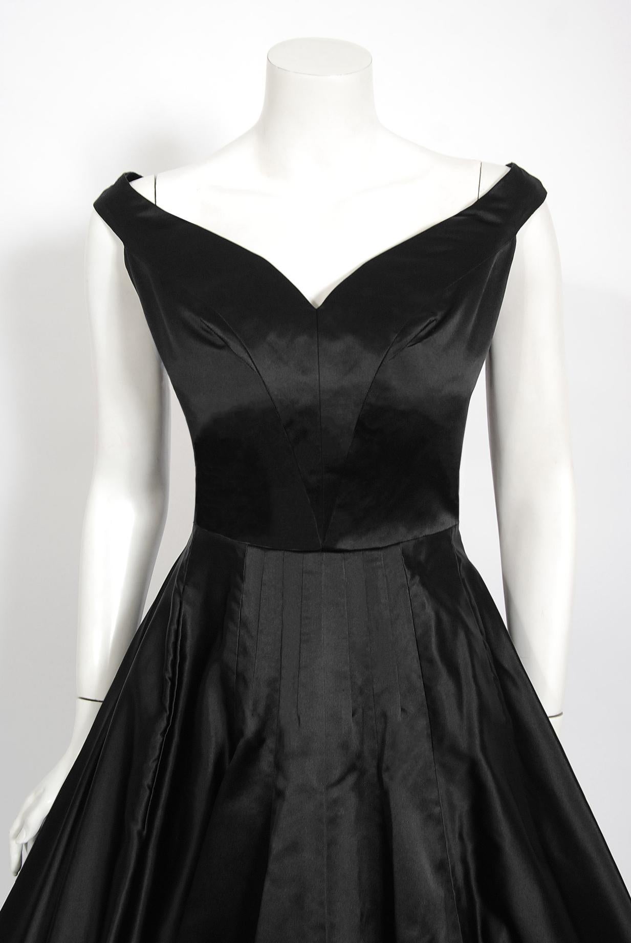 A gorgeous and rare Jame Galanos Couture black silk-satin dress dating back to the mid 1950's. Dedication to excellence in craftsmanship was the foundation of James Galanos' career. The quality of workmanship found in his clothing is unsurpassed in