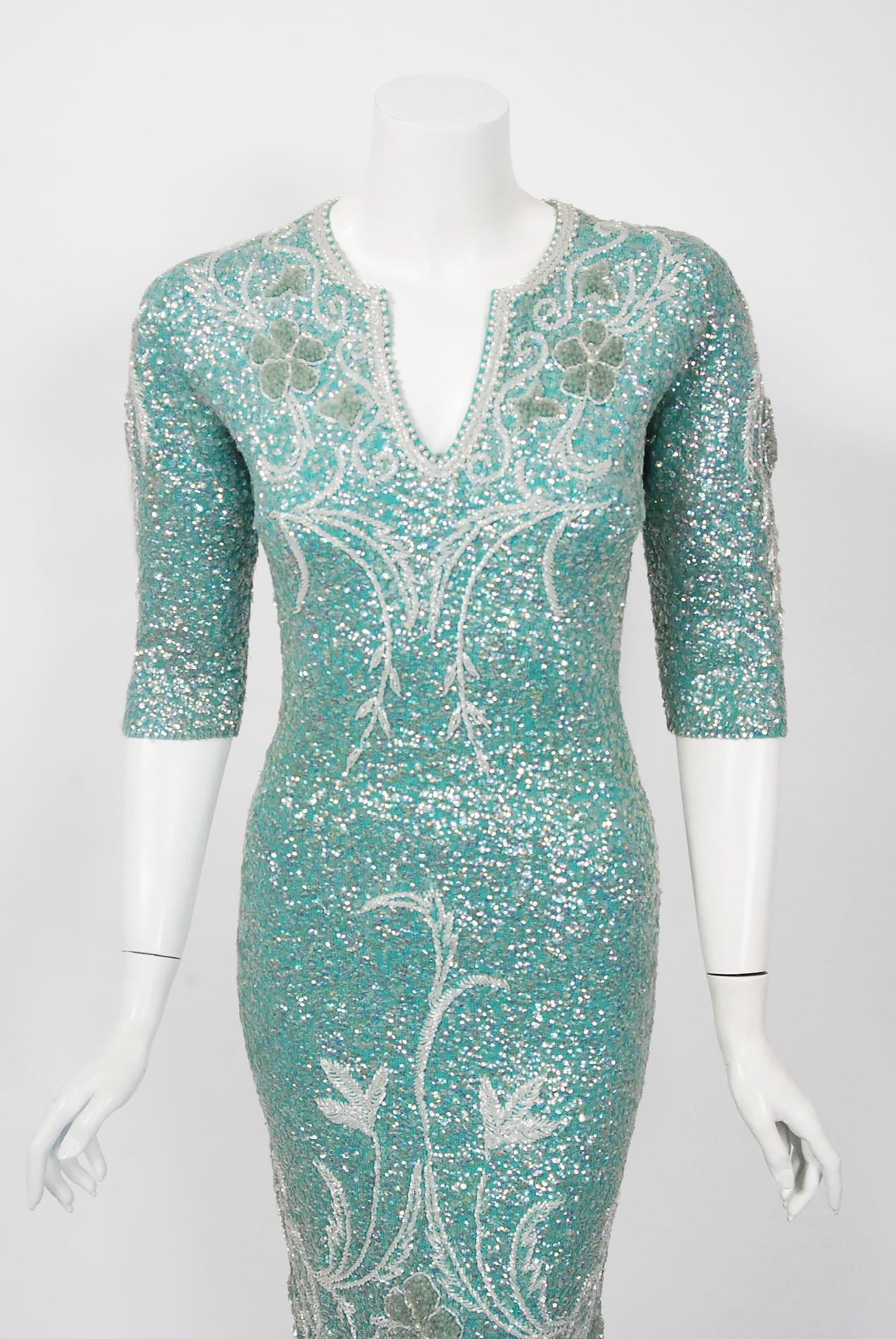 Mid-century Gene Shelly designer garments are in a class of their own. They are always fully-beaded by hand and fit to flatter the figure. This late 1950's treasure is fashioned in the most stunning turquoise blue color, featuring iridescent
