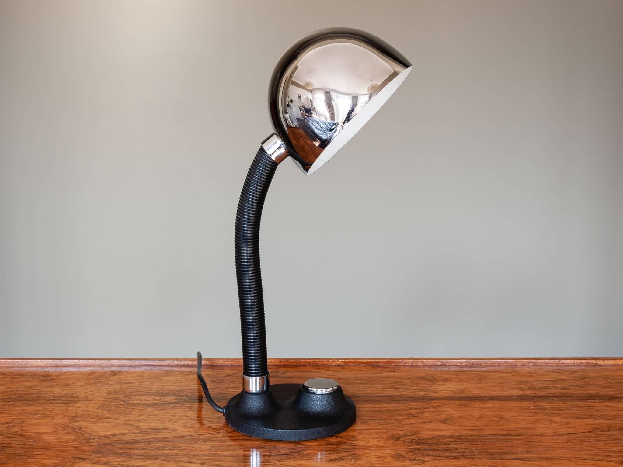 Vintage 1950s desk lamp manufactured by Egon Hillebrand Leuchtenfabrik in Germany. A functional Industrial heavy lamp in black and chrome. The cast iron base supports the large chrome domed shade with a large feature matching chrome button on/off