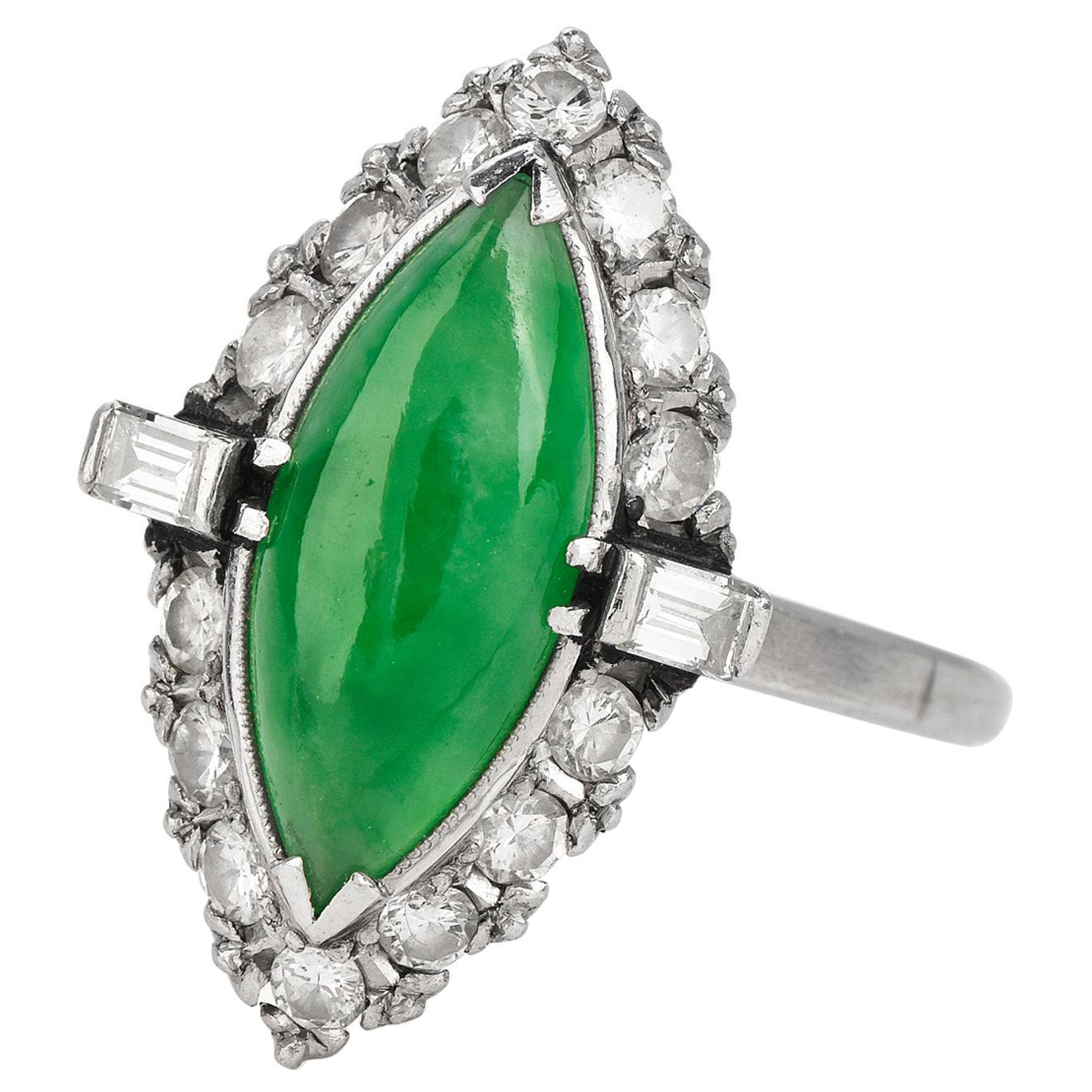 Exquisite Vintage GIA Certified Jade and Diamond Navette Style Ring are characterized by the Vibrant Apple Green of the center stone.

Carefully crafted in solid platinum and with a total weight of approximately 6.30 grams,

This Antique deco ring