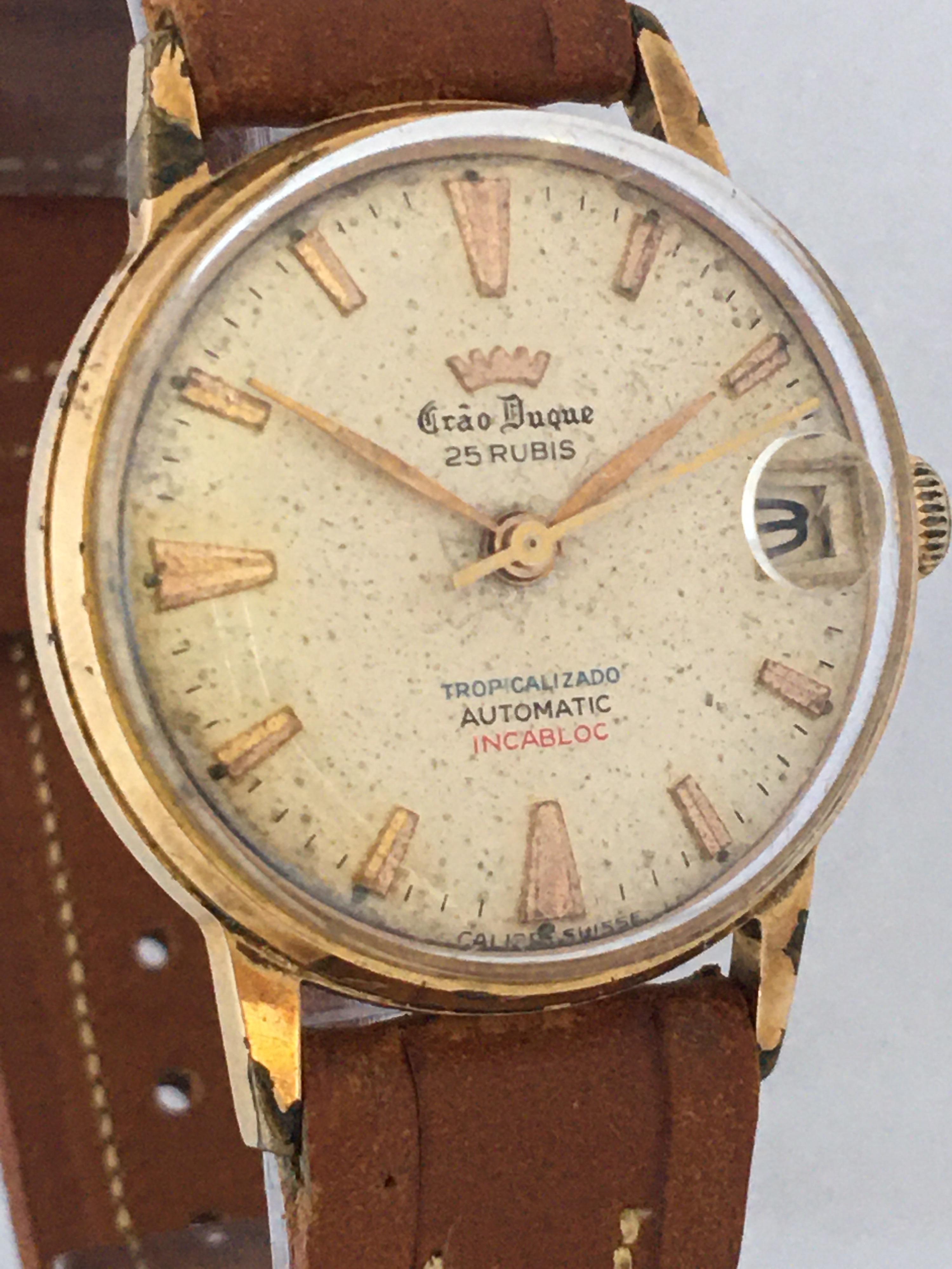 This beautiful pre-owned mid-size automatic Swiss watch is in good working condition and is running well. visible signs of ageing and wear with the dial is a bit worn, the gold plated case is a bit tarnished and some tiny scratches on the stainless