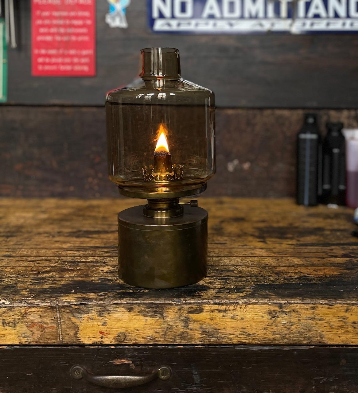 A nice warm, unrestored, and unpolished piece of old world Scandinavian decor for your interior. A rare kerosene or oil table lamp, model L-47 designed and produced by Hans-Agne Jakobsson in Markaryd, Sweden. 

In this example there is a small