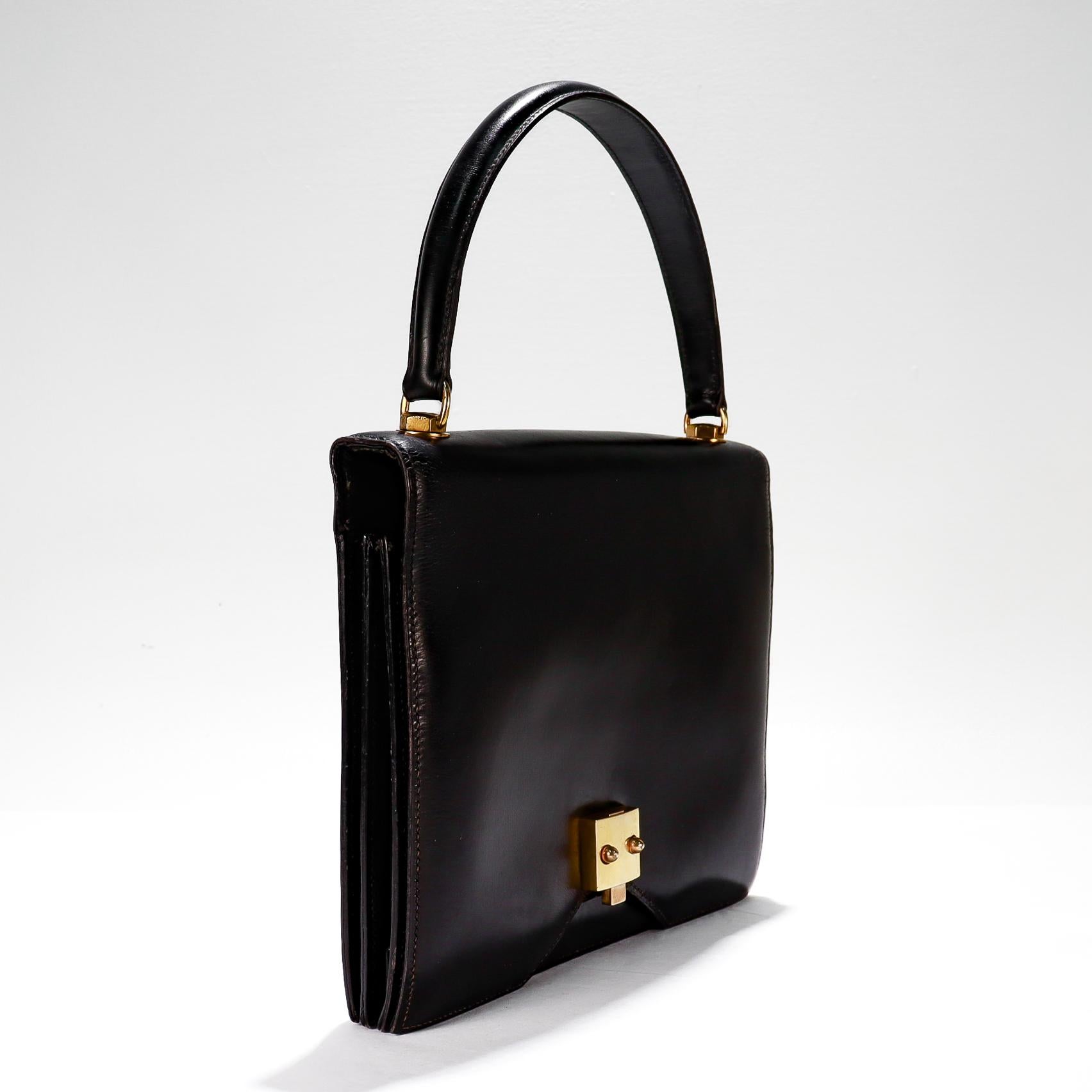A rare 1950s Hermes bag.

By Hermes.

In Black Box calf leather with gold plated hardware. 

In the rare G8 form. An elegant and practical take on the classic envelope bag, halfway between the Hermès Lido and the Hermès Piano bags from the 30s and