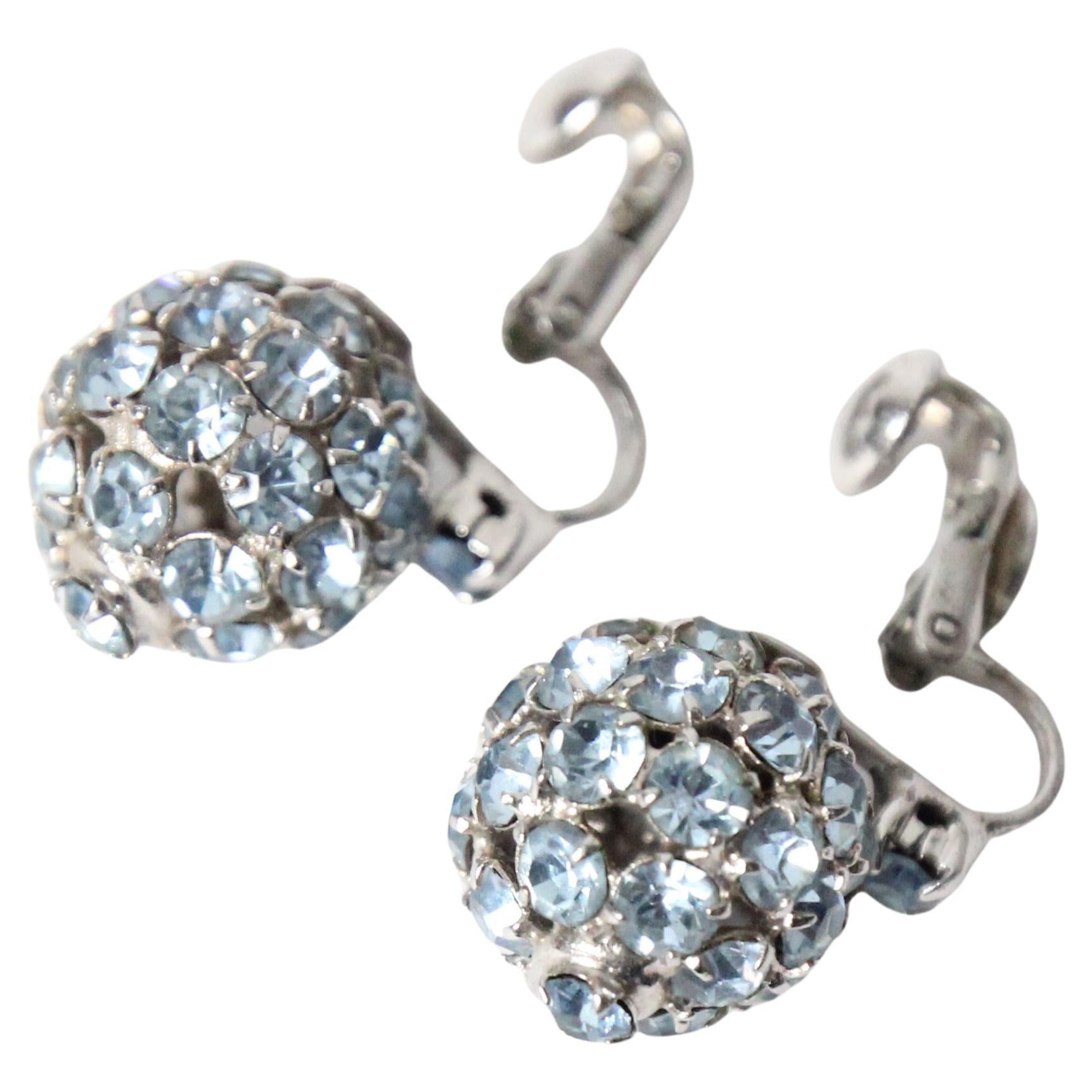This wonderful pair of 1950's clip on earrings by Kramer of New York, are the perfect statement piece to add to your jewellery collection. 
Made up of claw set glass rhinestones in the softest shade of ice blue, in a domed design, finished with