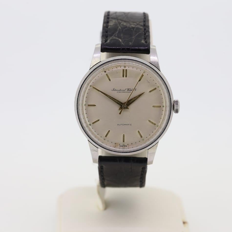This is a vintage stainless steel watch from the designer IWC (International Watch Company). The watch features all its original pieces but the strap and buckle have been replaced with newer versions. The watch dates back to the year