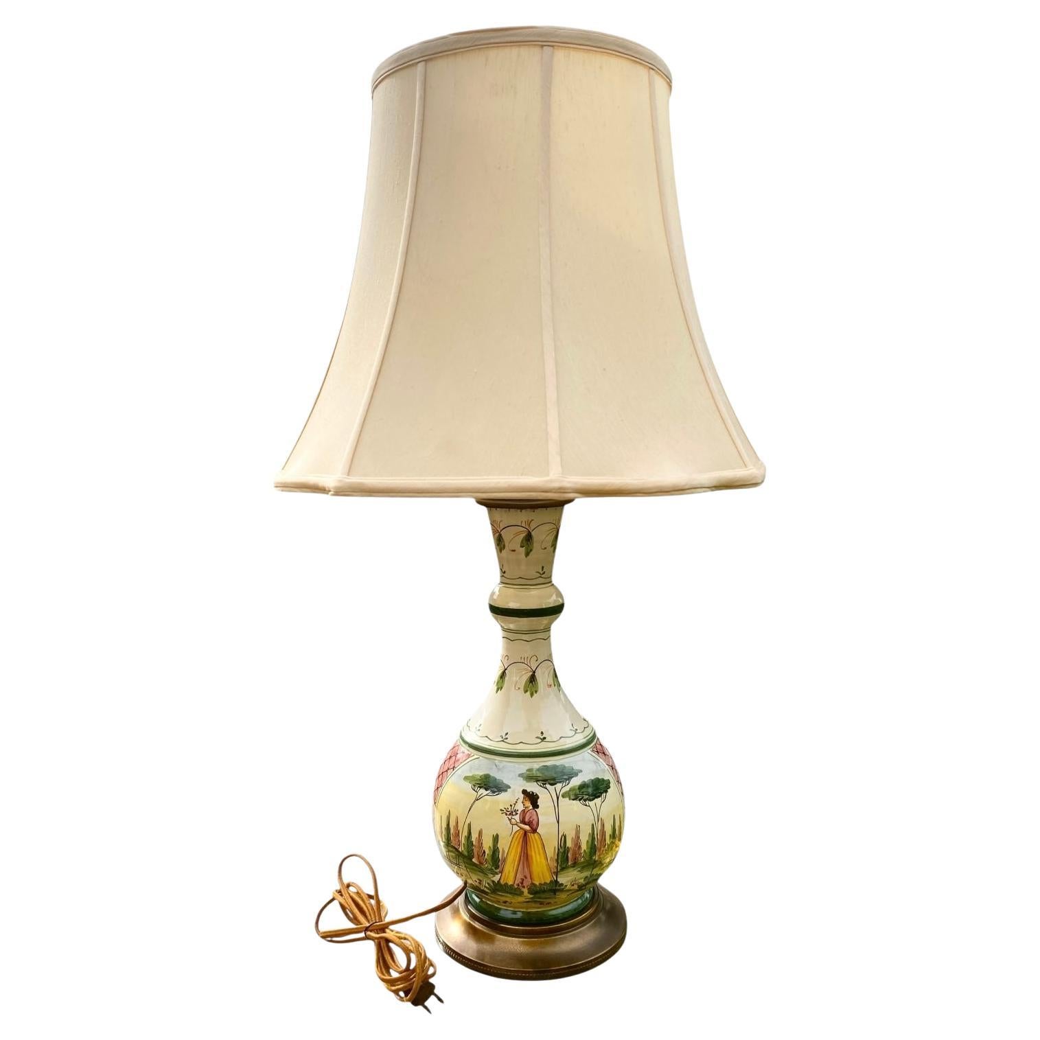A vintage hand painted Italian faience or glazed pottery table lamp with fanciful, bucolic scenery and brass fittings, attributed to Bitossi. 

Early Bitossi marks on lamps, particularly those from the 1950s and 1960s, often featured distinct