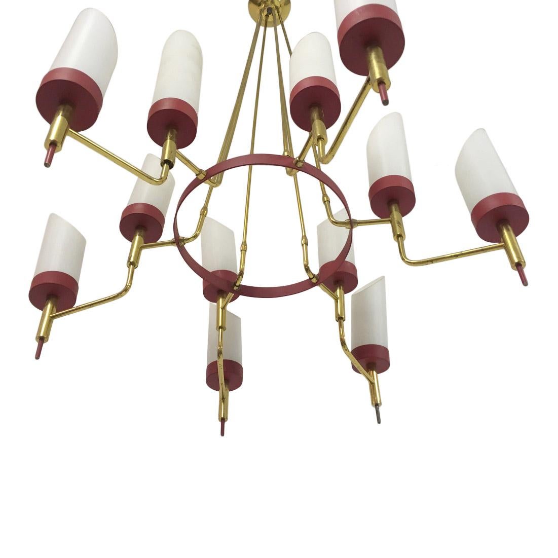 Brass framed chandelier
Painted red metal
With white glass diffusers
Italian 1950s.